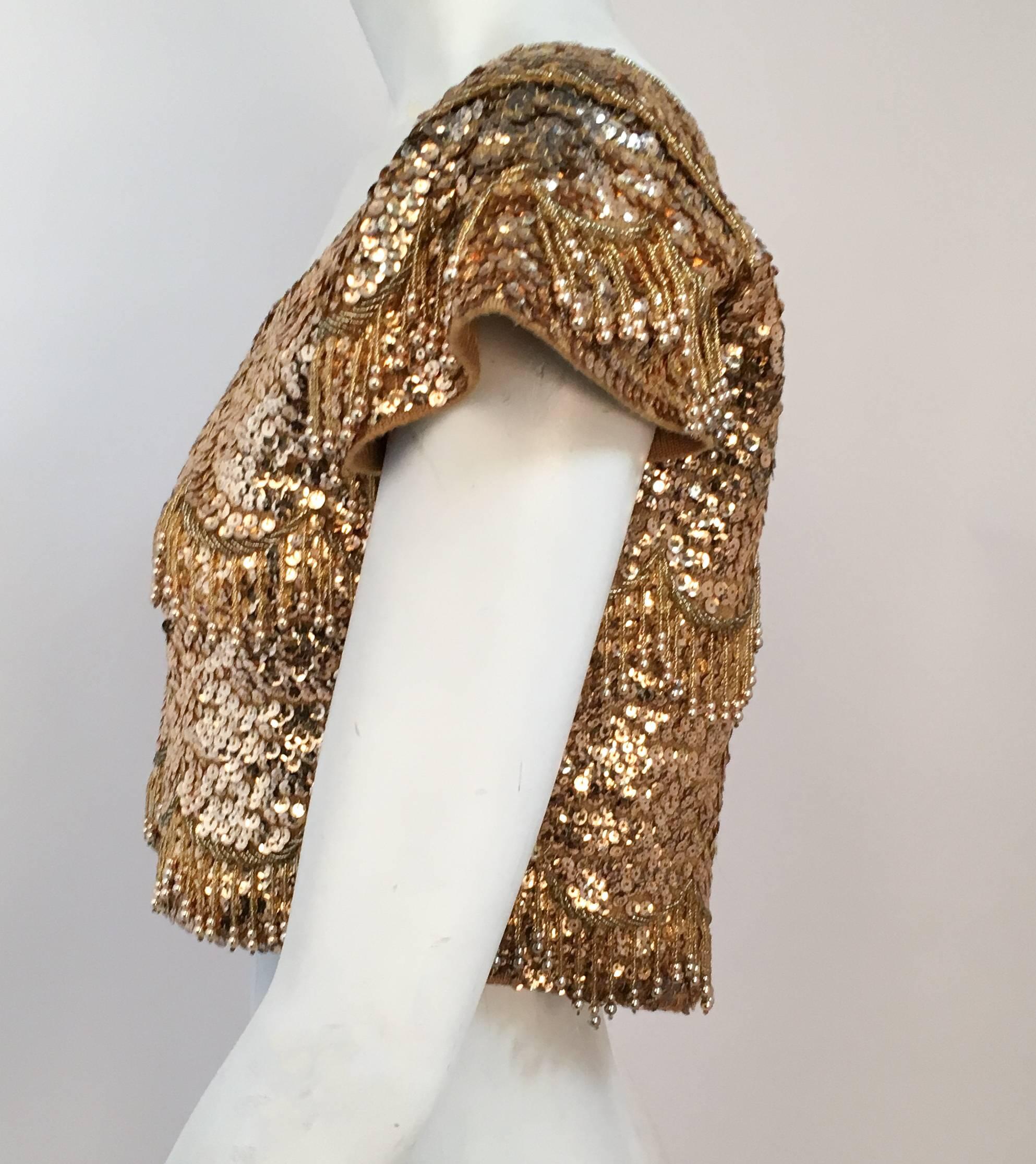 50s Gold Beaded Cropped Top. Gold beads and sequins on sweater knit fabric. Hook and eye back closures. 