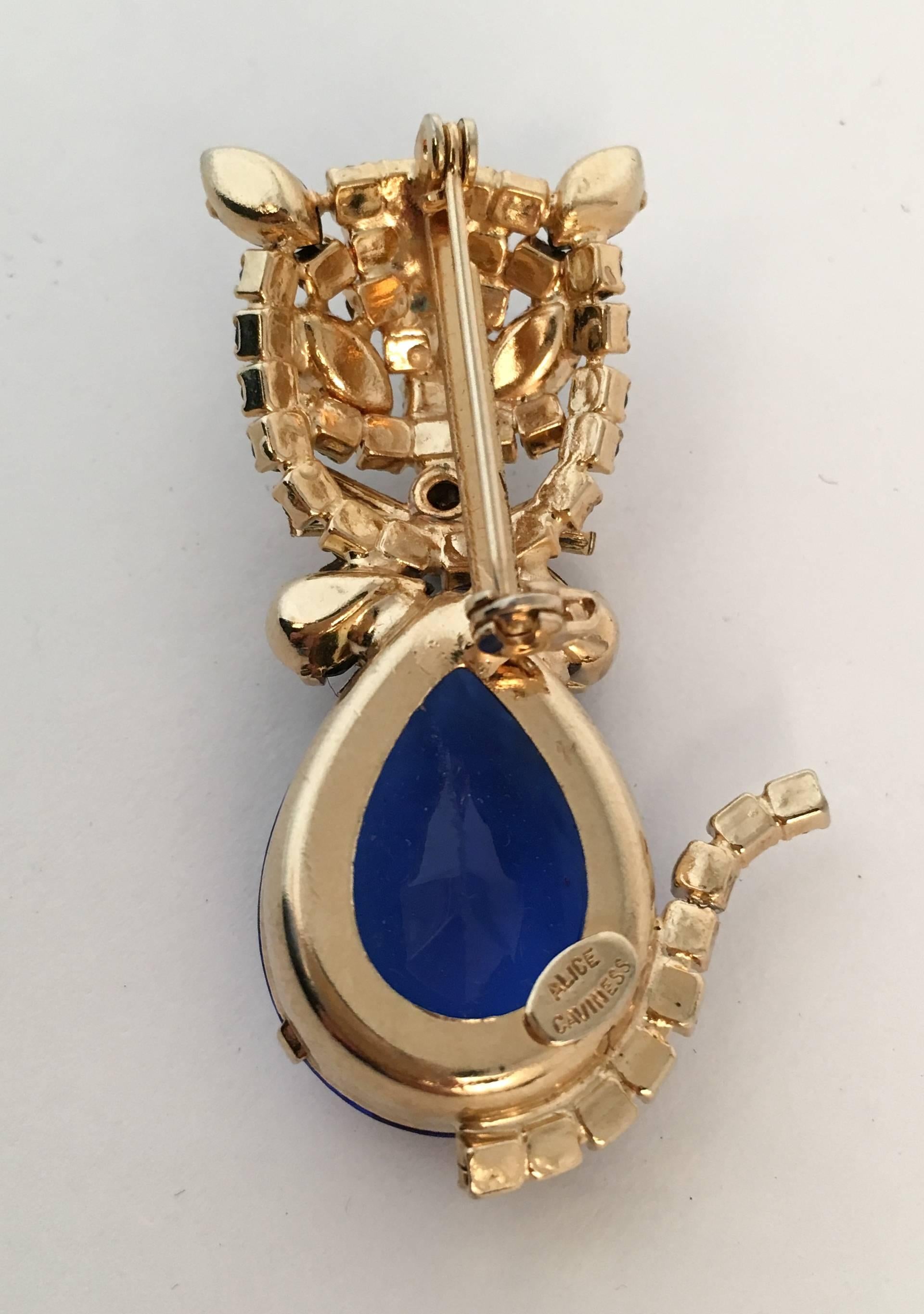60s Alice Caviness Blue Rhinestone Cat Brooch. Gold tone hardware, blue and green rhinestones. 