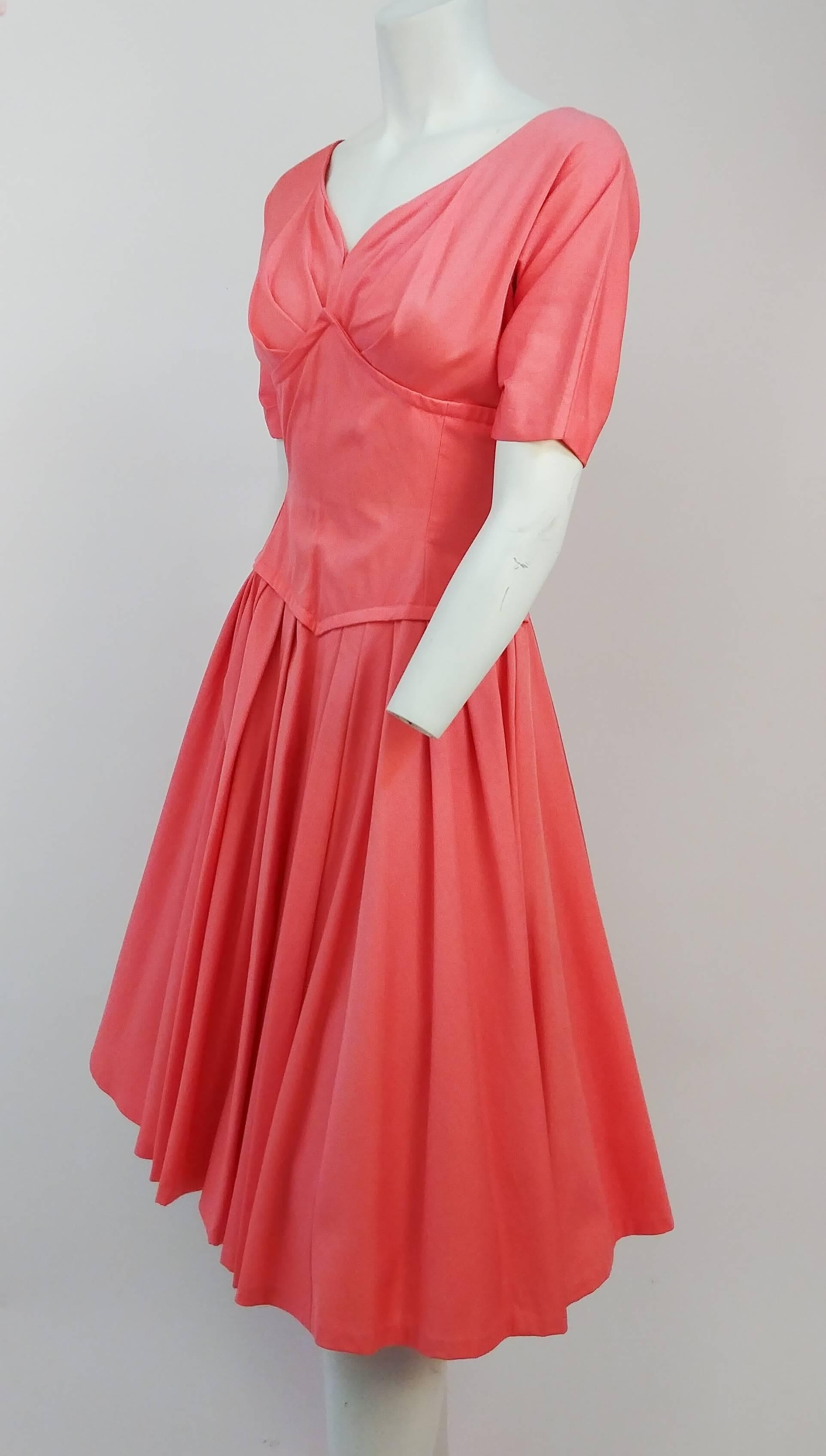 50s Salmon Pink A-Line Dress. Pleated skirt details. Interesting corset-shaped bodice. Zips up back. Dress shown over a petticoat in photo for additional support.