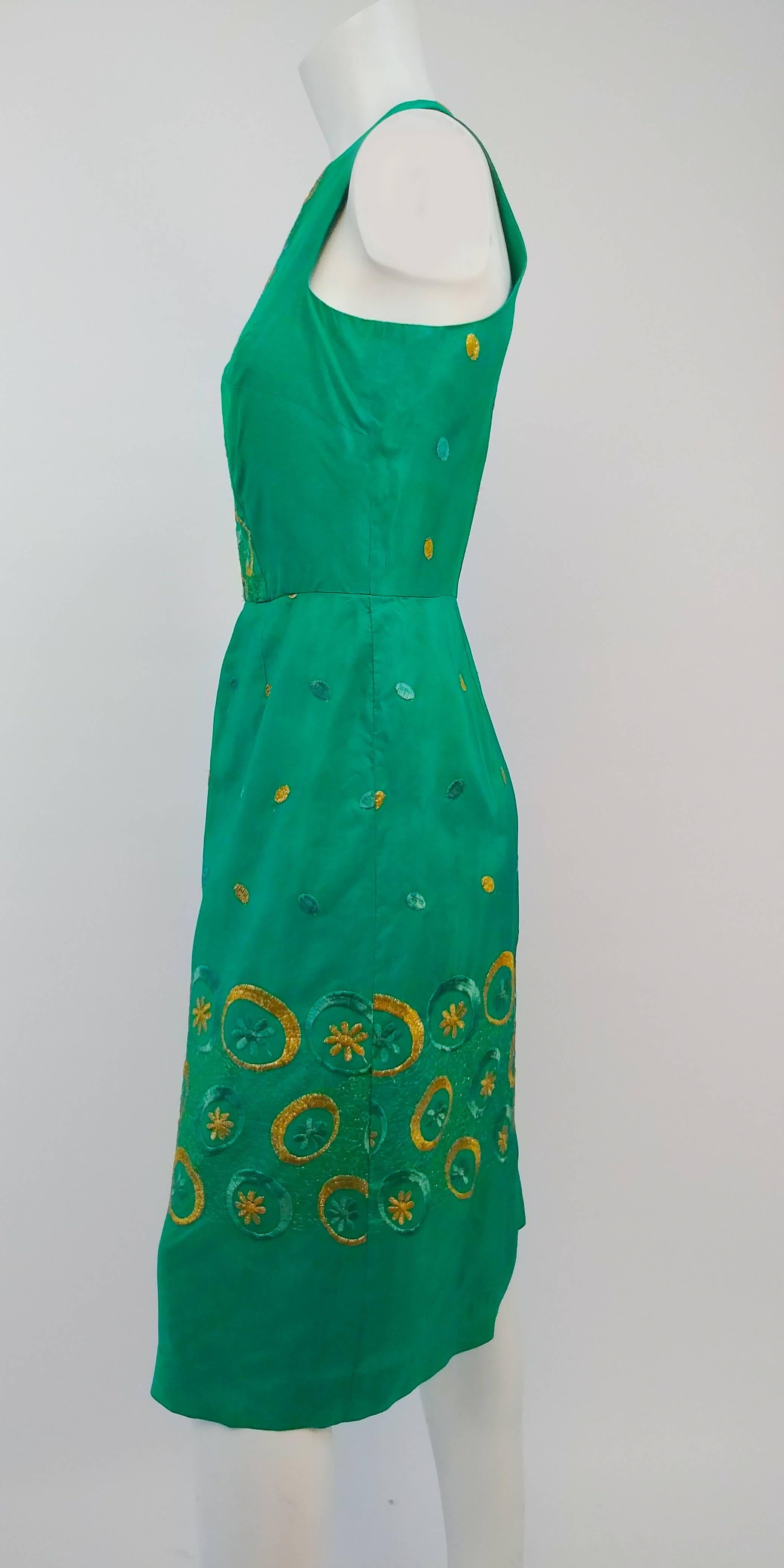 1960s Emerald Green Embroidered Cocktail Dress.

This dress is about a size 12 to 14. The measurements are as follows:

Bust: up to 42