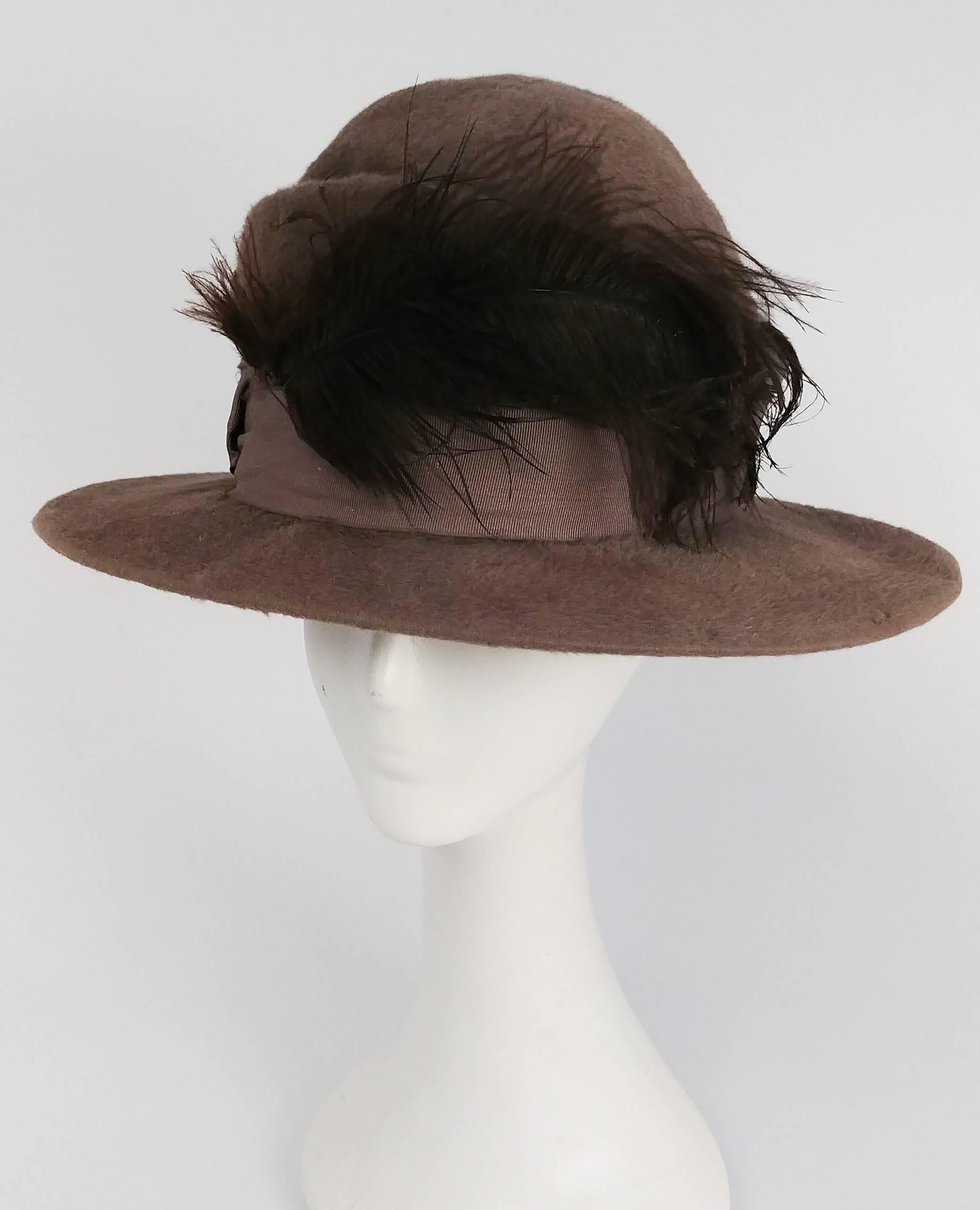Edwardian Round Fur Felt Hat w/ Feather. Grosgrain ribbon hat band (slight marks shown in photo) with brown feather and art deco brooch decoration. 