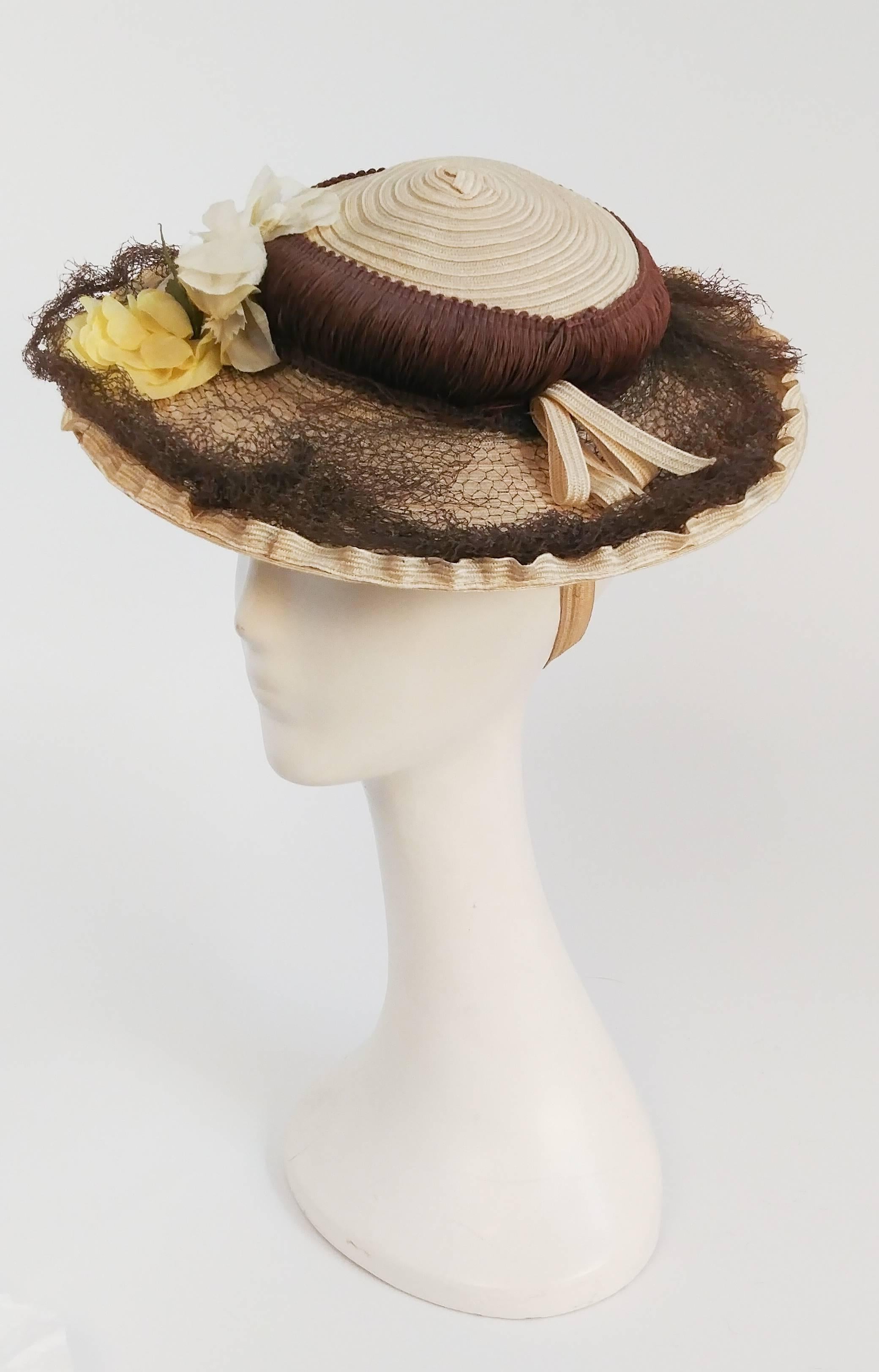 1930s Cream Floral Day Hat. Net & flowers embellish the brim of the hat, and flowers also decorate the back underside for a great view no matter the angle. Strap holds hat to back of head.