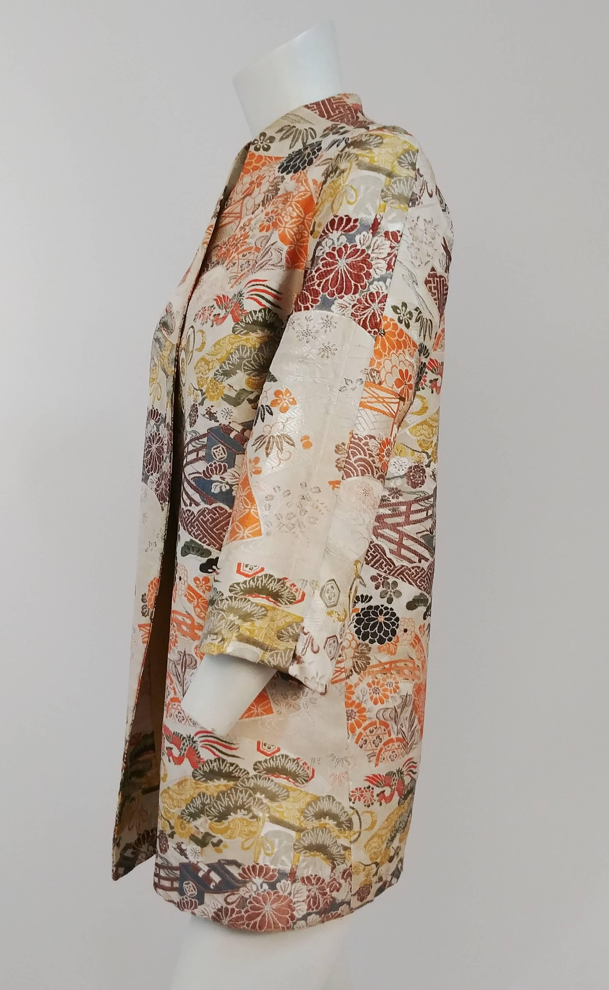 1960s Asian Brocade Jacket. High collar, no closures. Glove length sleeves. Pleated sleeve detail. Fully lined. 
