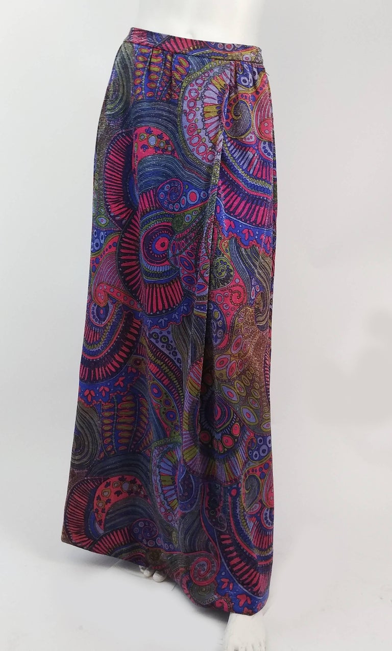 1970s Purple Metallic Psychedelic Couture Skirt. Skirt features a faux wrap silhouette with extra drape on one side. Comes with a sash that can be used in a variety of ways. Hand finished, silk lining. 