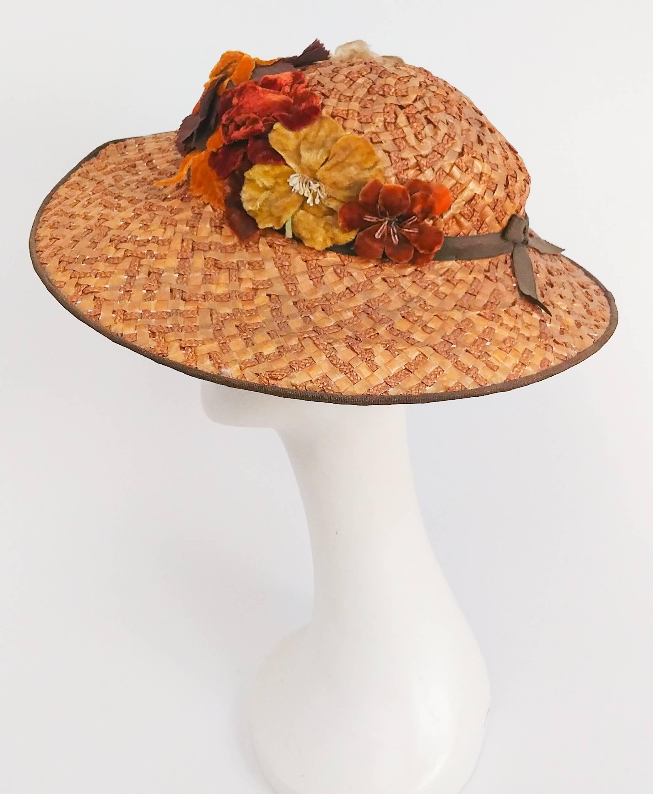1930s Wide Brimmed Hat w/ Velvet Flowers. Harvest coloured flowers adorn the front of this hat, finished in a crossed ribbon in the back. 