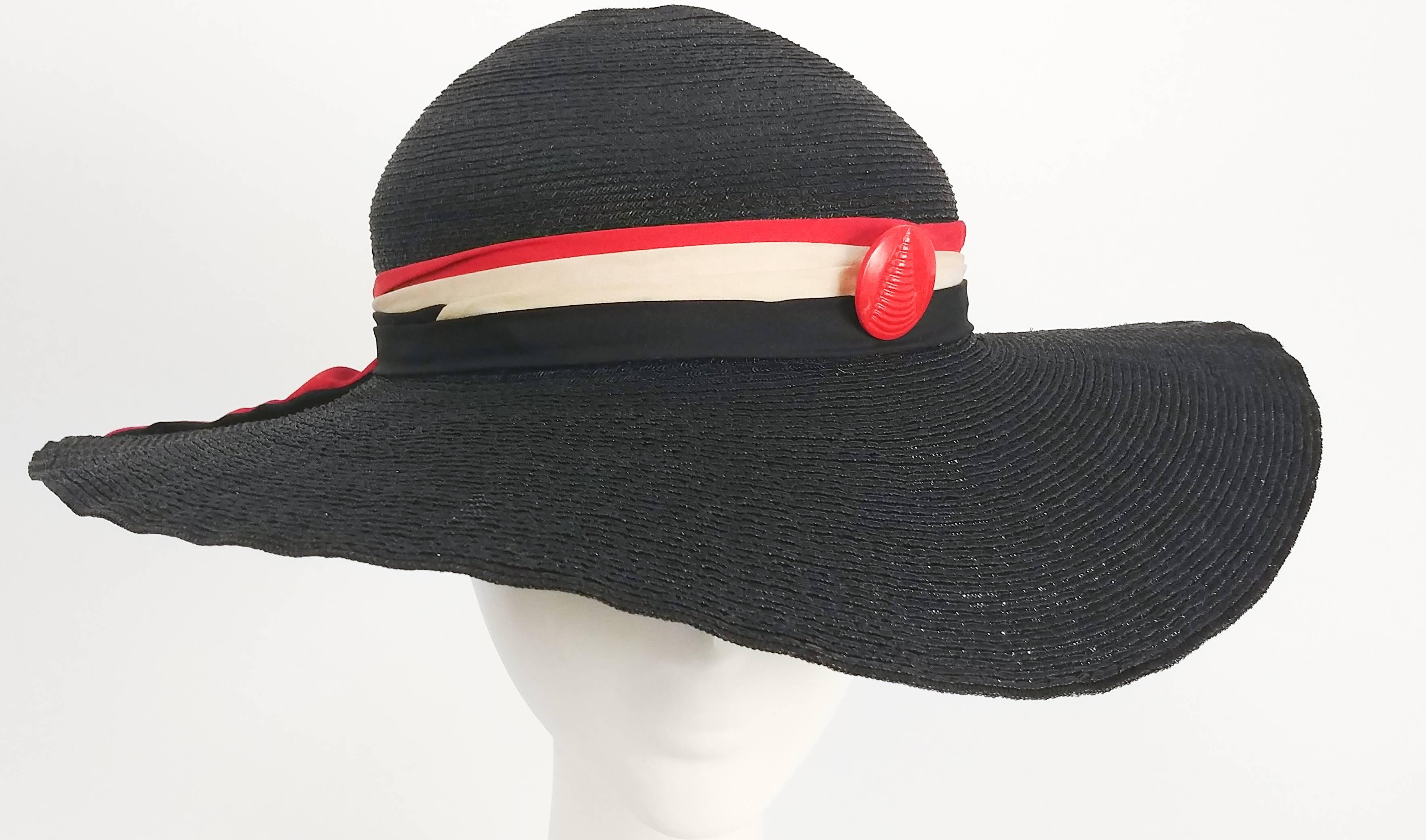 1930s Black Straw Sun Hat w/ Red & White Silk Ribbon Trim. Finished in bow on back of head. Adorable red button embellishes side. Fully lined inside and is attached to head w/ elastic for the back of the head. 