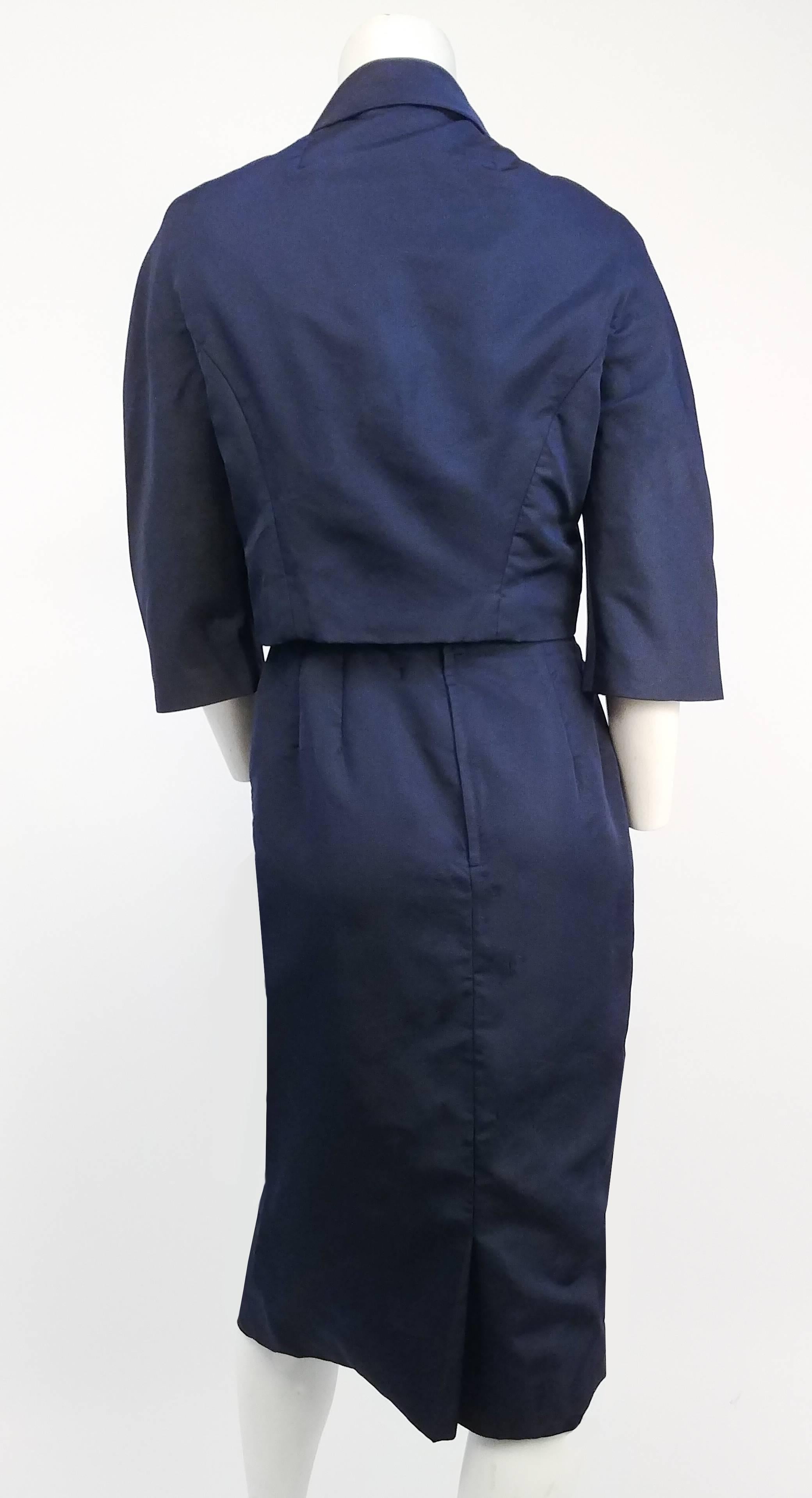 1950s Navy Sheath Dress and Jacket Set. This set is an impeccably constructed navy silk faille sheath dress with matching cropped jacket. The neckline has a ruffled asymmetrical trim that compliments the weave of the fabric beautifully, which is