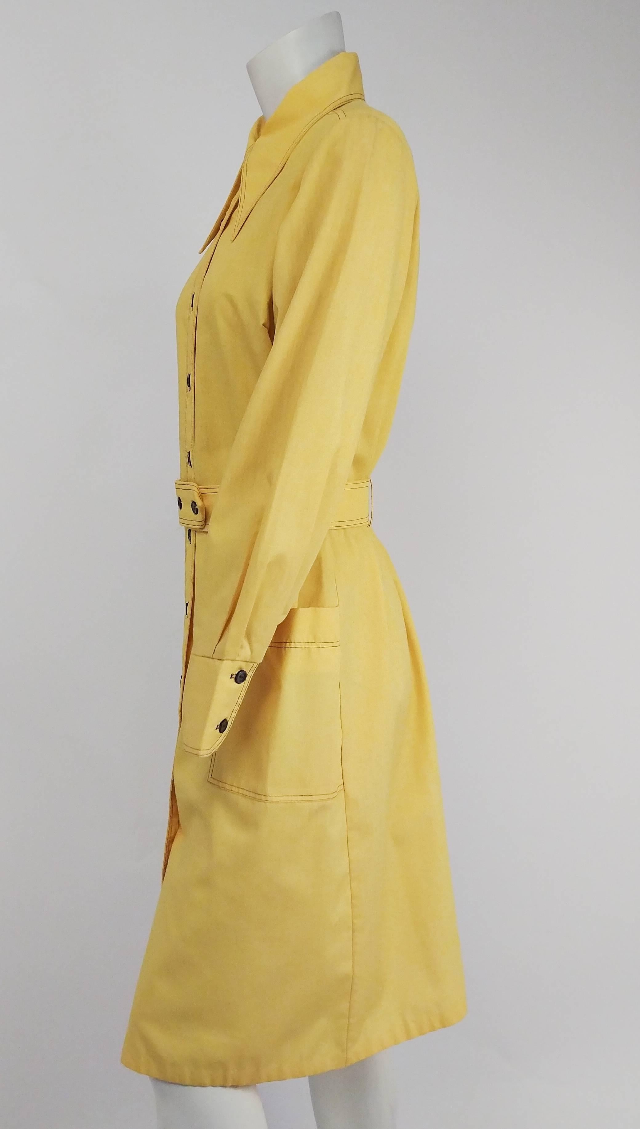 1970s Yellow Cotton Shirtdress. Matching belt included. Contrast topstitching. Two front pockets. Buttons up front. 