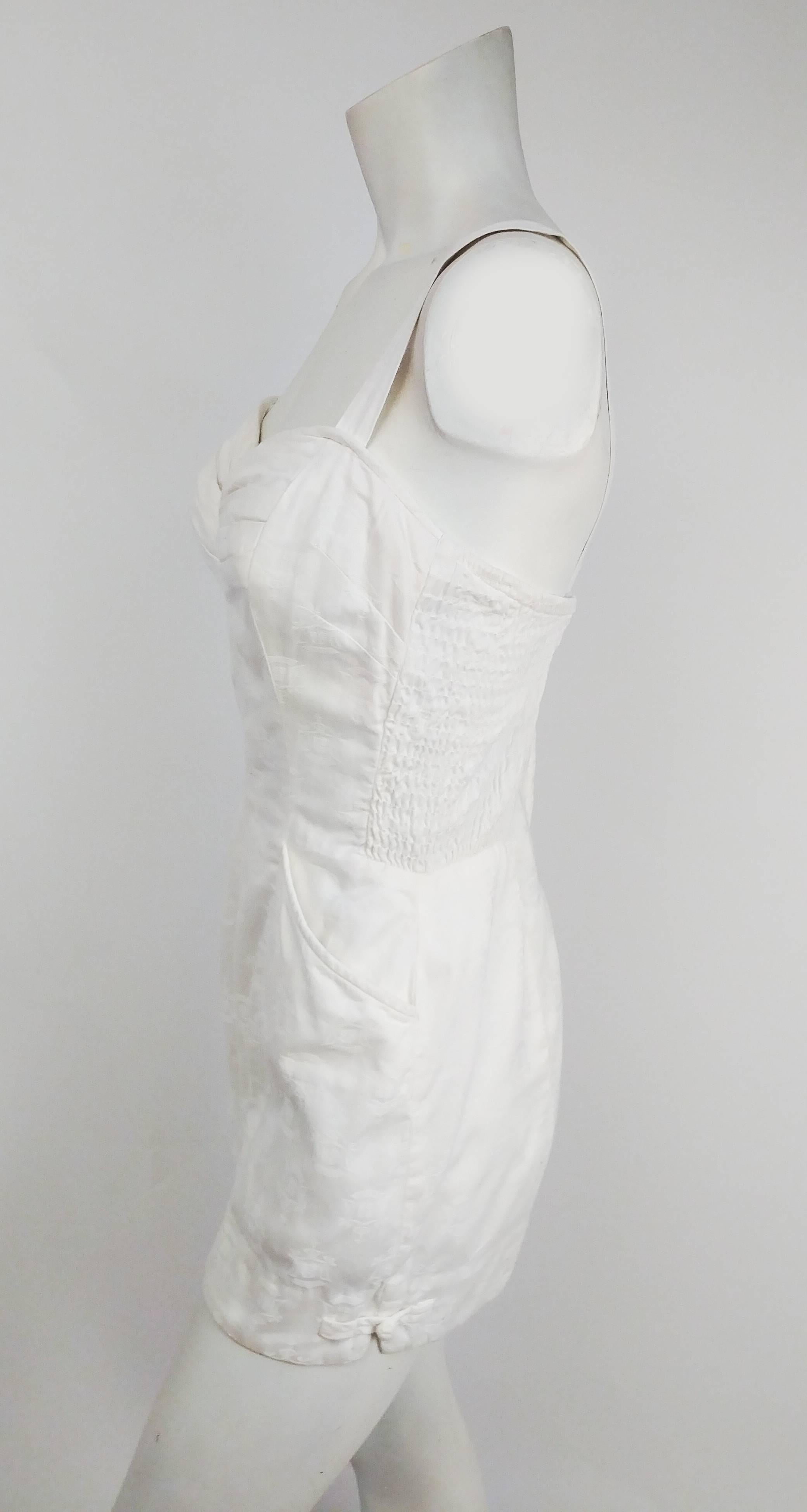 1950s Kamehameha White Cotton Damask Romper. Two front pockets. Frog clasp detail at side leg seams. Zips up back. Side panel shirring. Built-in cups in lining for support. Adjustable back straps. 