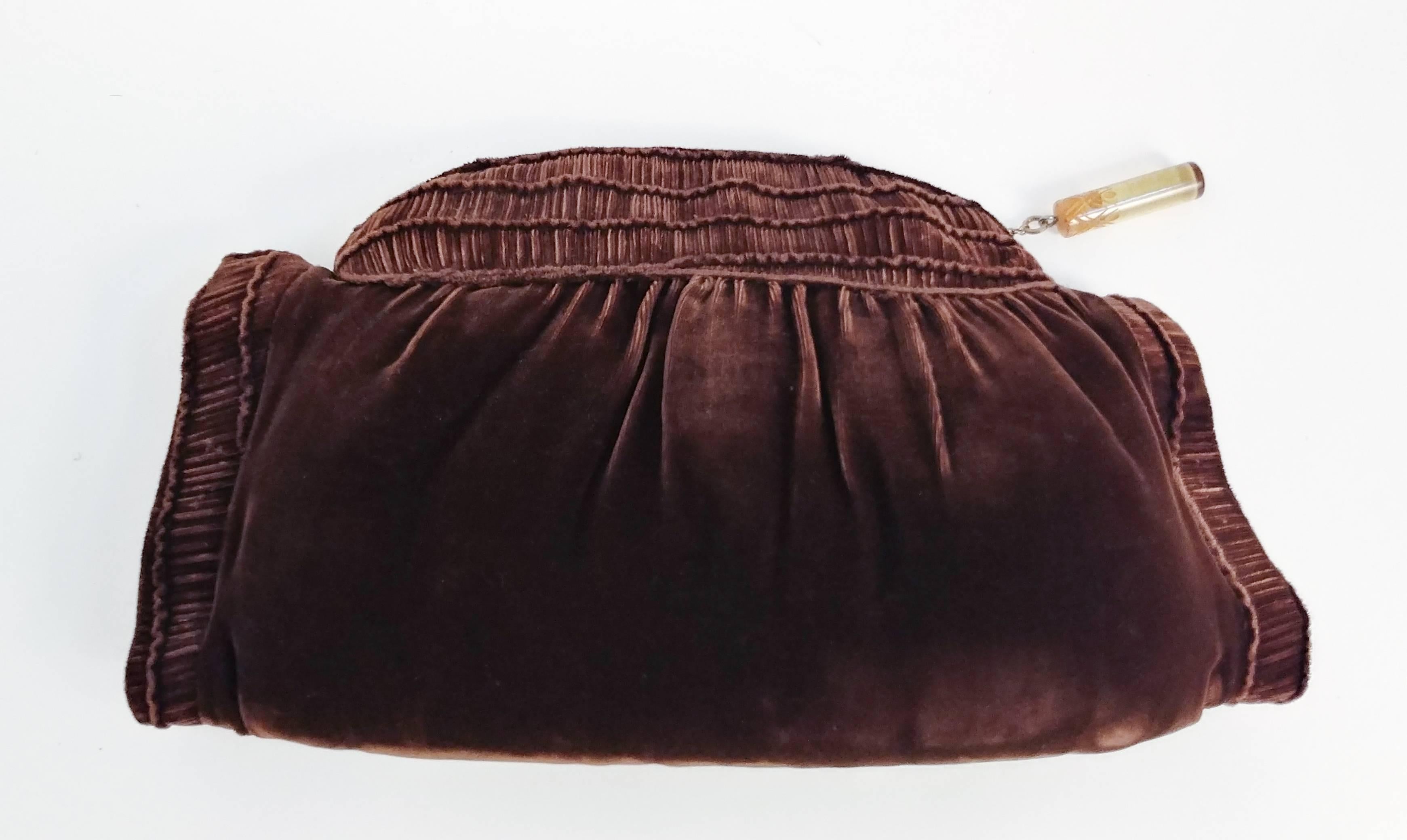 1940s Brown Velvet Muff. Ruched detail along top and arm holes. Velvet is in excellent condition with no noticeable pressing on fabric. Opens along top with metal zipper with lucite zipper head detail. Built-in change purse. Keep your hands warm and