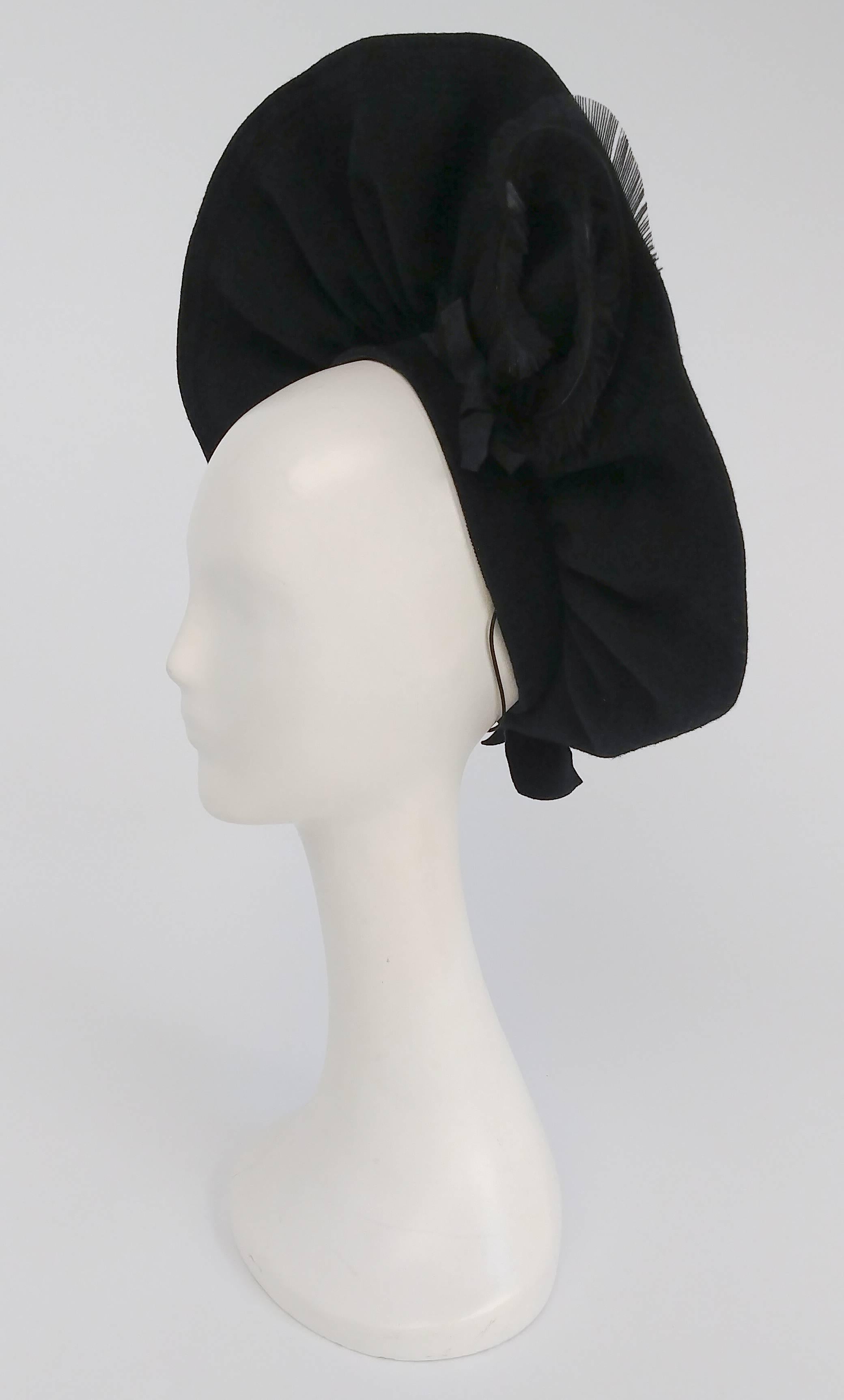 1940s Black Wool Ruffled Hat w/ Curled Feather. Black hat sits on the back of head, held in place with elastic band. 