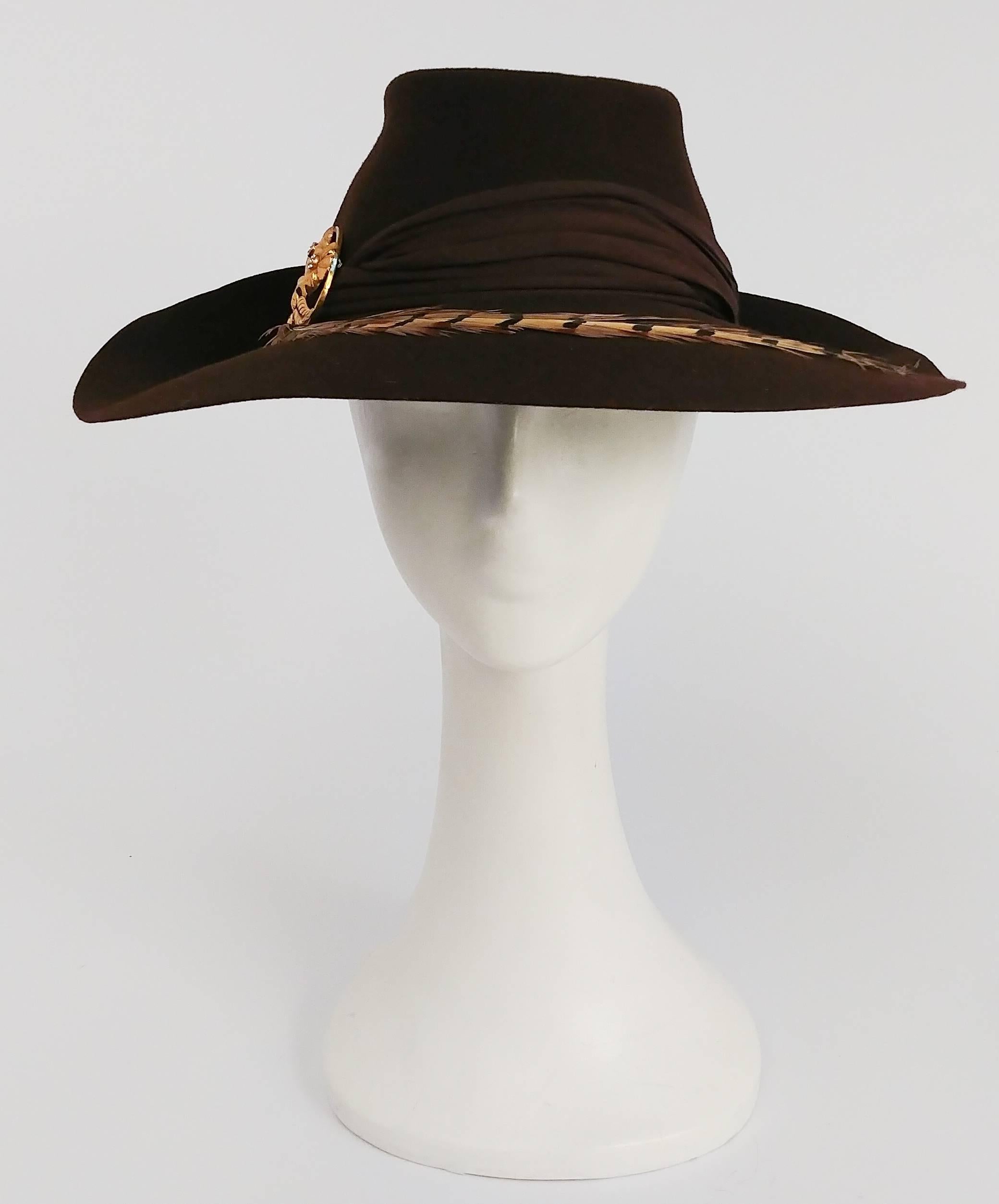1940s Brown Large Brimmed Hat w/ Pheasant Feather. Brim is flipped up and gathered at back. Side embellishment of a gold-tone flower pin. Held in place with elastic band. 