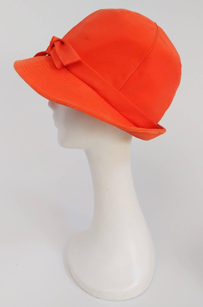 1960s Orange Mod Velvet Cloche Hat. Pieced top, topstiched brim that flips up, with front bow decoration. 21.5