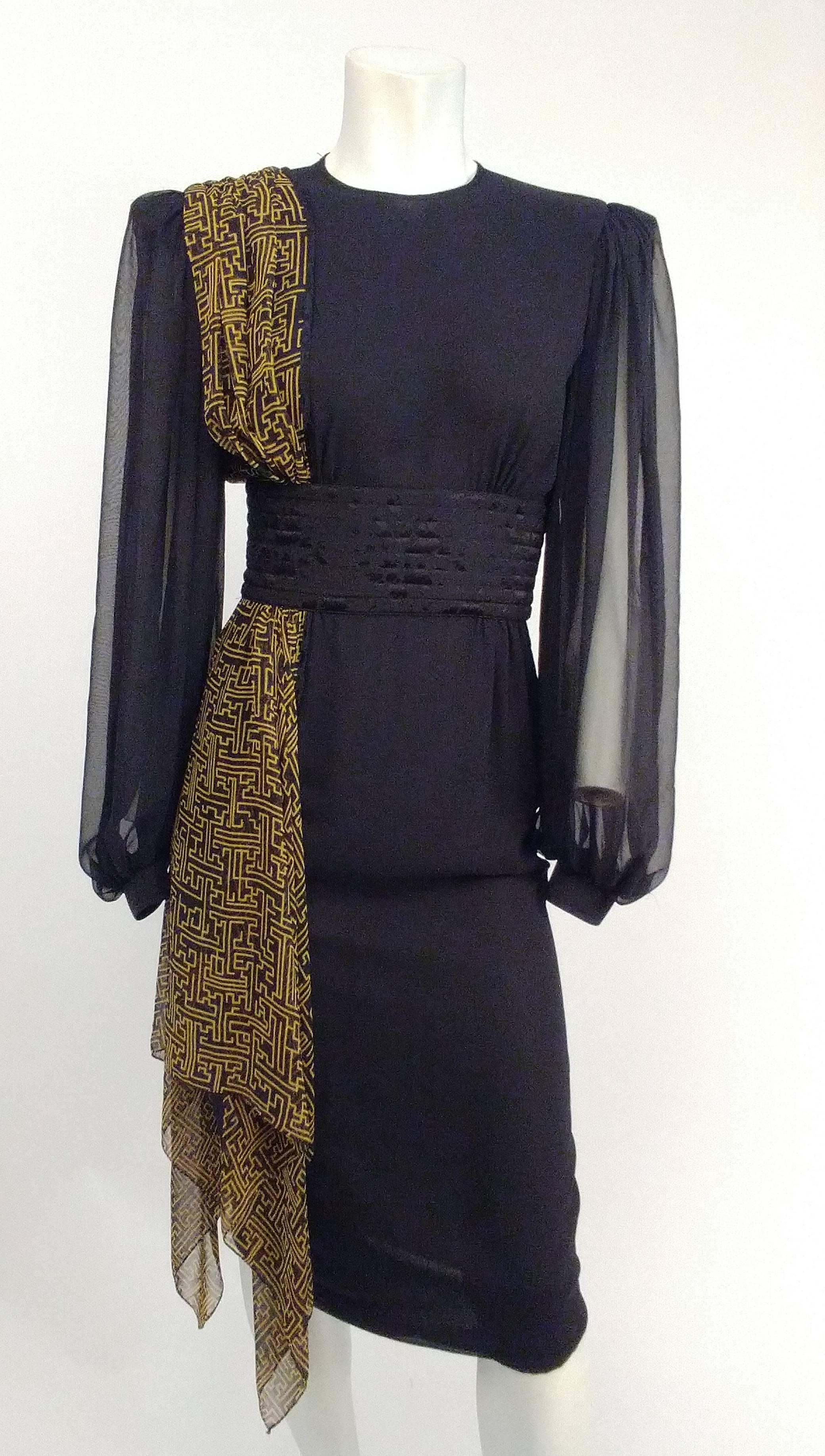 1980s Asymmetric Draped Chiffon Dress. 1940s inspired silhouette. Geometric printed chiffon drapes over one shoulder of dress, ends with a kerchief hem. Top stitched jacquard wide belt cinches in waist. Gorgeous full chiffon sleeves. Zips up back to