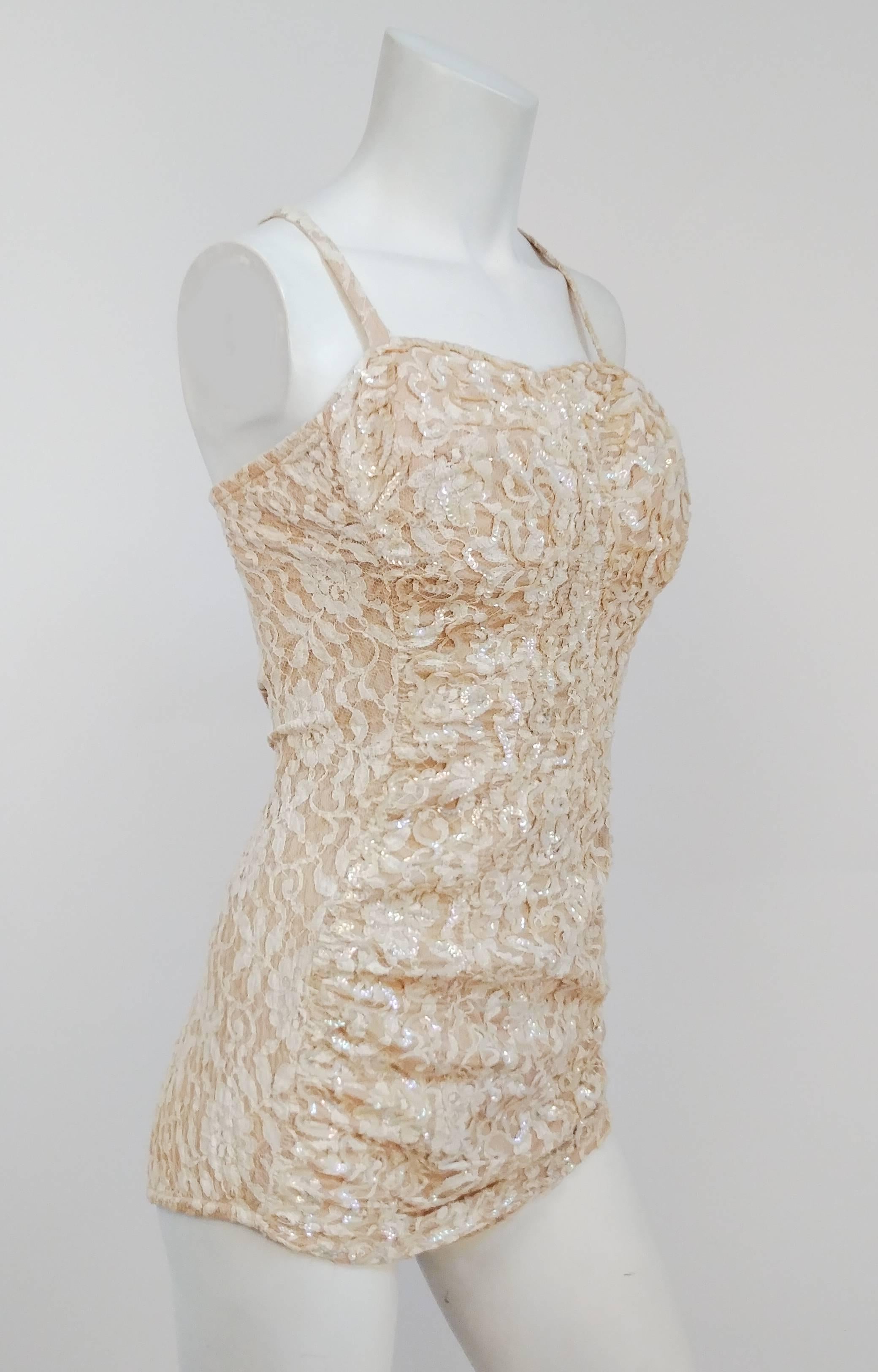 1950s Ivory Sequin Bathing Suit. Sequins sewn over lace, with additional lining and boned bust. Crossover back straps button in place. Back zipper closure. Ruched front for extra va-va-voom. 