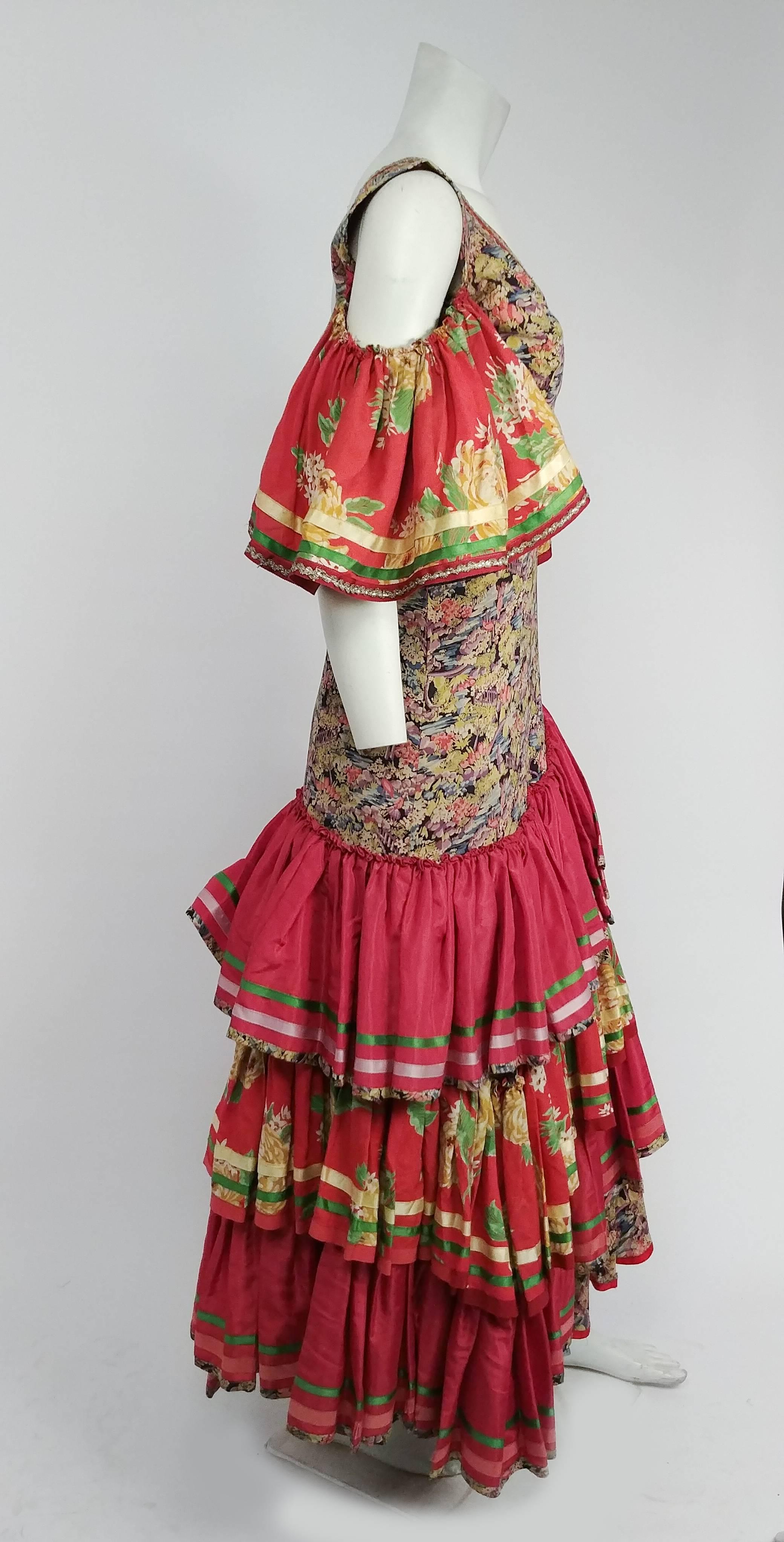 1950s Colorful Printed Flamenco Dress. Trimmed with satin ribbon and metallic lace. Bare shoulders, large ruffled sleeves. Multi-tiered ruffled skirt in contrasting fabrics. 