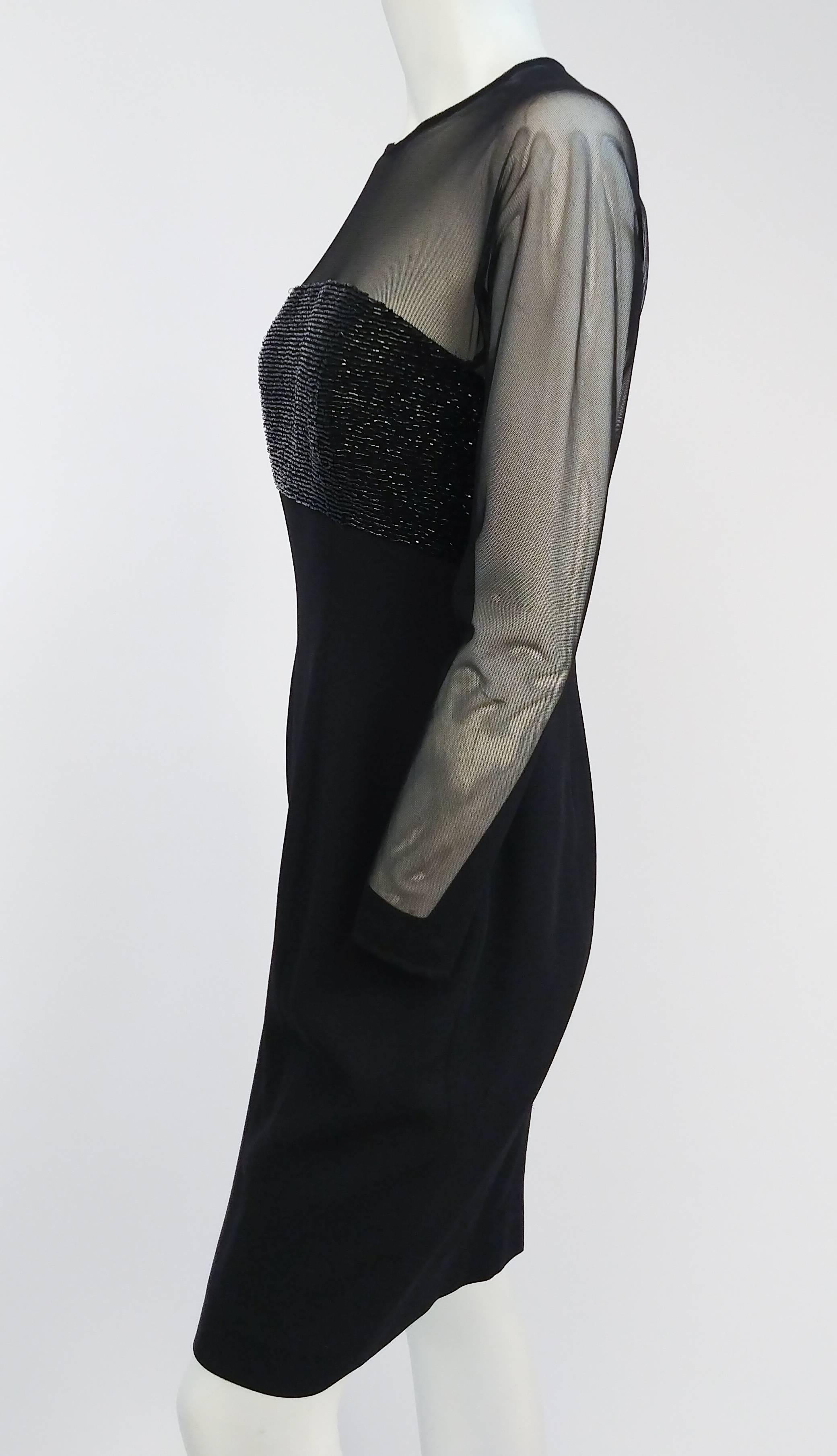 1990s Carmen Marc Valvo Mesh & Beaded Cocktail Dress. Black crepe skirt, glass beaded bust, mesh sleeves neckline. Faux button up back, zips up. 