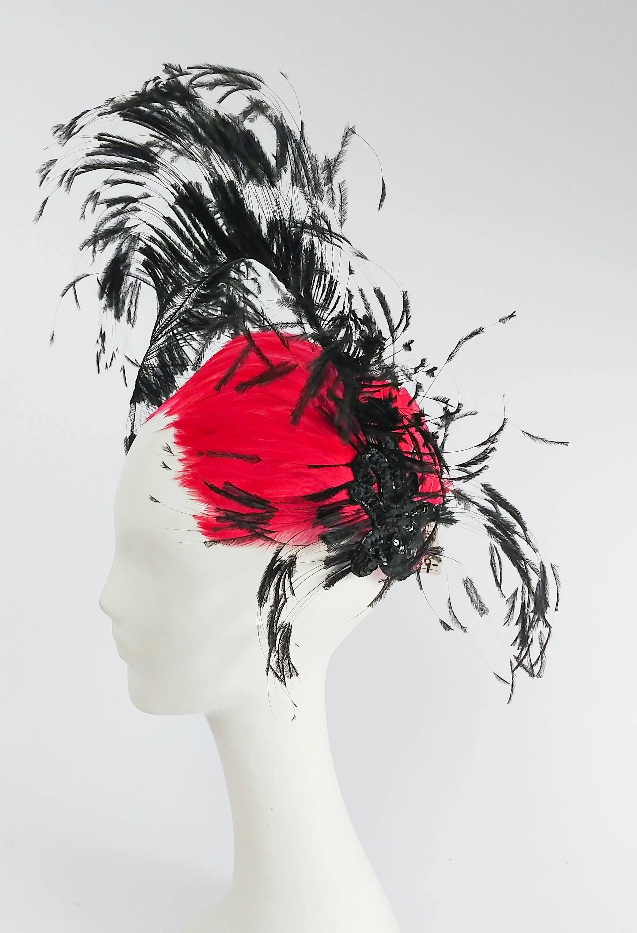 1960s Bright Pink & Black Showstopping Feather Hat. This hat is definitely a statement piece! Embellished with perfect hand-cut and curled black feather with black sequin detailing on the side, this eyecatching pink color will ensure all eyes are on