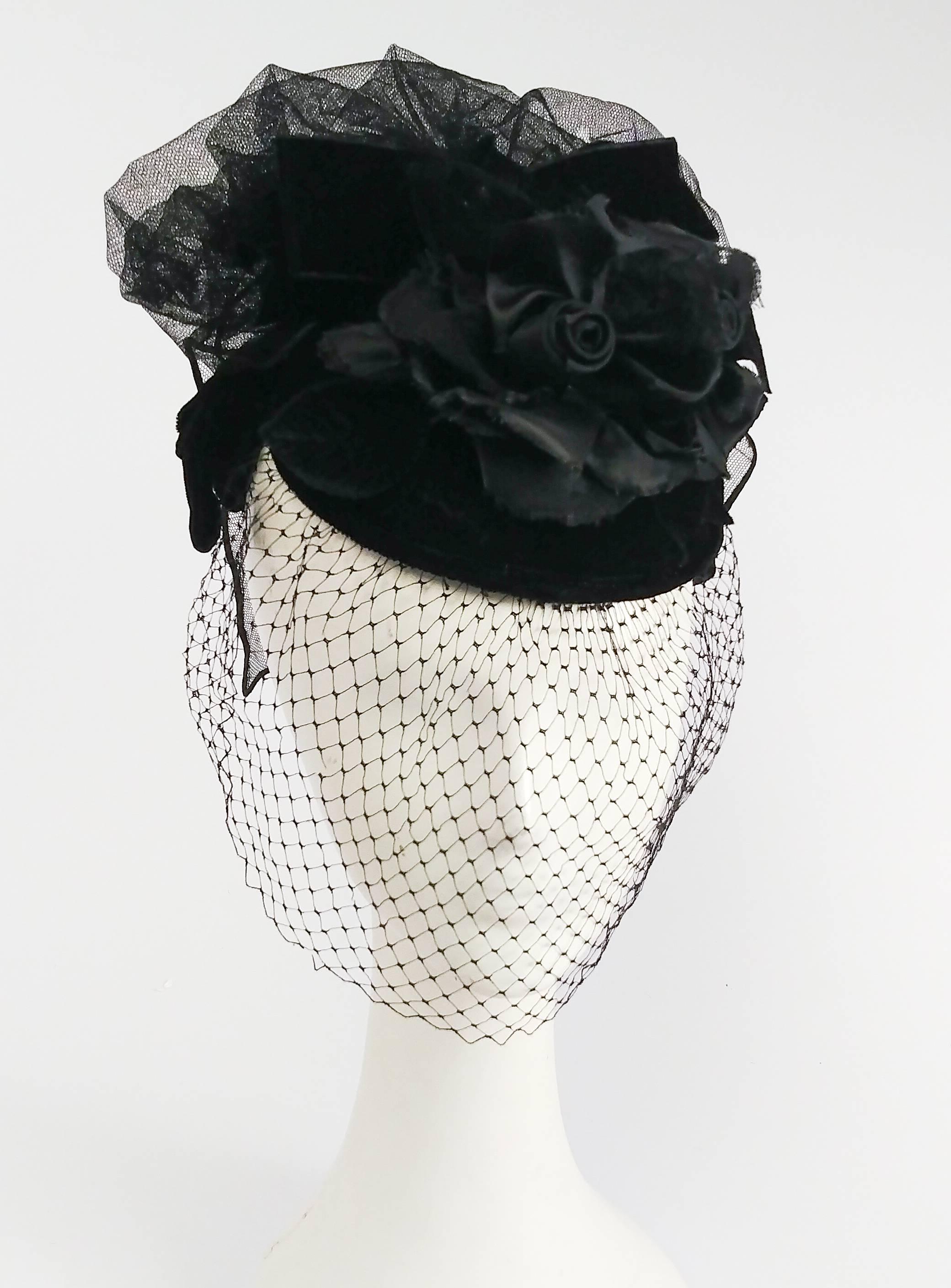 1940s Veiled Edwardian Style Cocktail Hat. Embellished with roses and beautiful cascade of fabric on back of hat. Elastic band holds hat to back of head. 