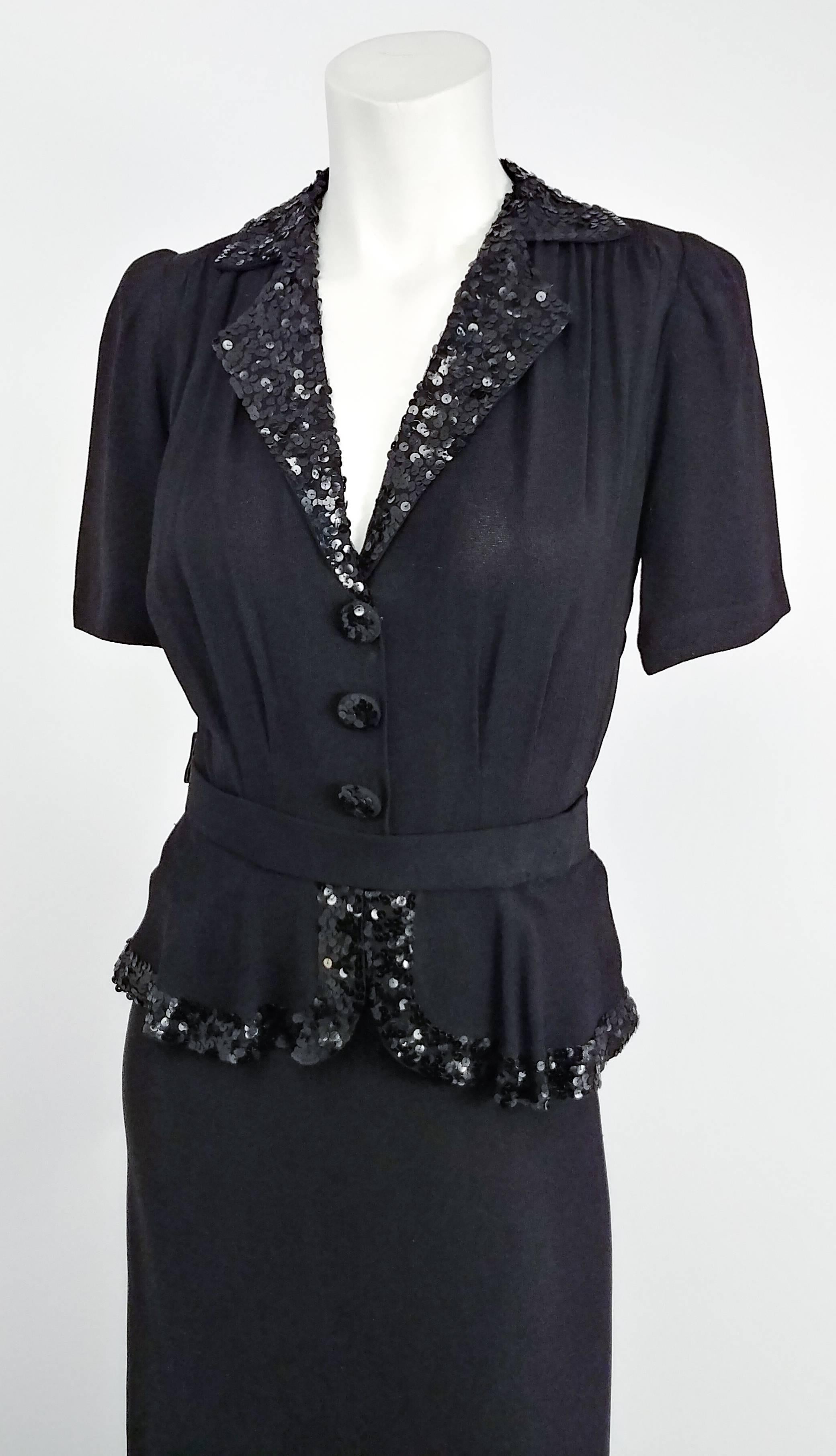 1930s Black Crepe Day Dress w/ Sequins. Comes with matching belt. Faux top/skirt look. Sequins on collar, front buttons, and peplum edge. Hook & eye closures at side, side seam of peplum snaps shut over that. Padded and gathered shoulders. 