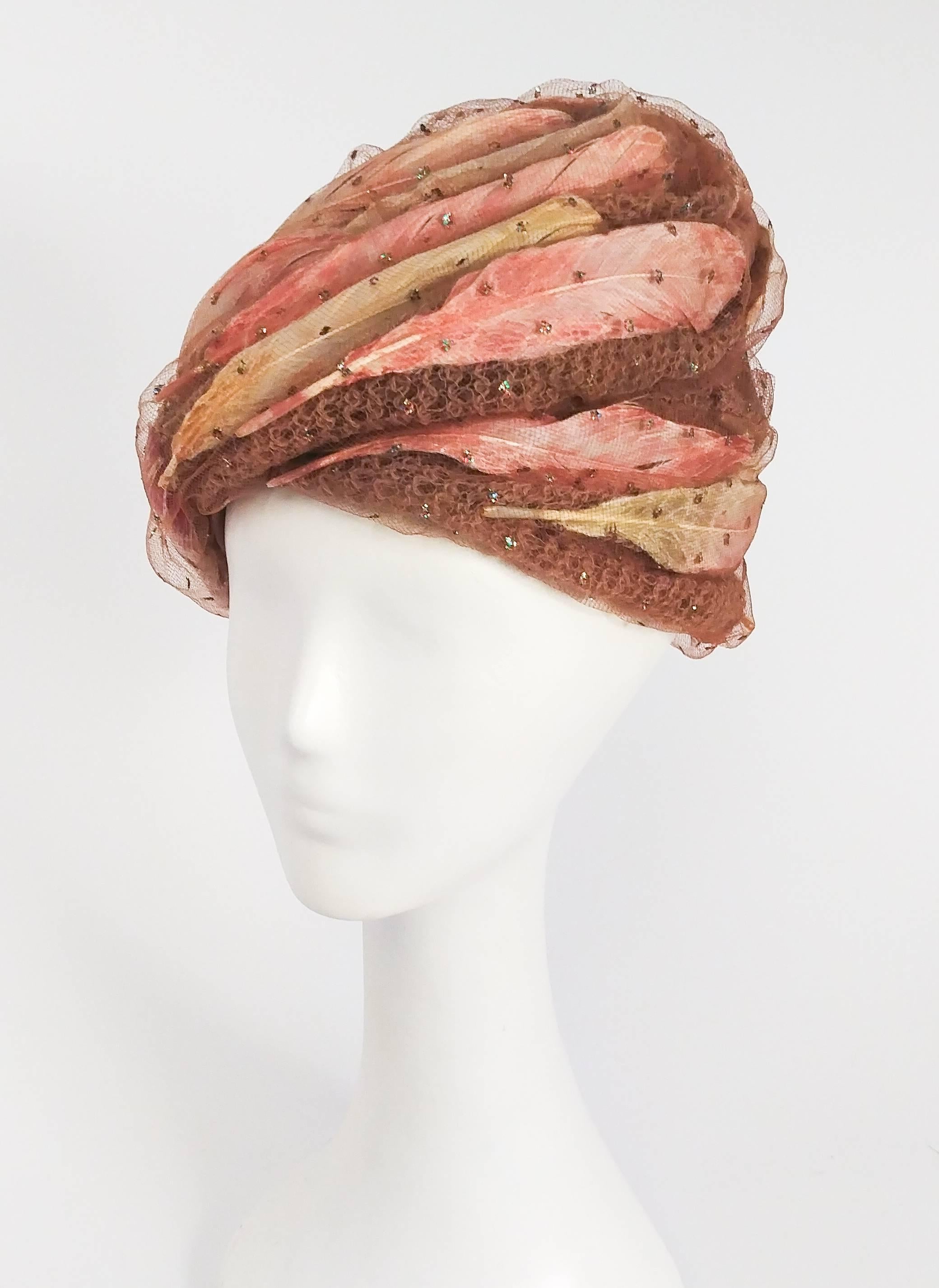 1960s Christian Dior Tulle Turban w/ Feathers. Overlay of tulle fabric with glittery dots, draped in a swirled pattern over pink and peach feathers. 22" circumference. 