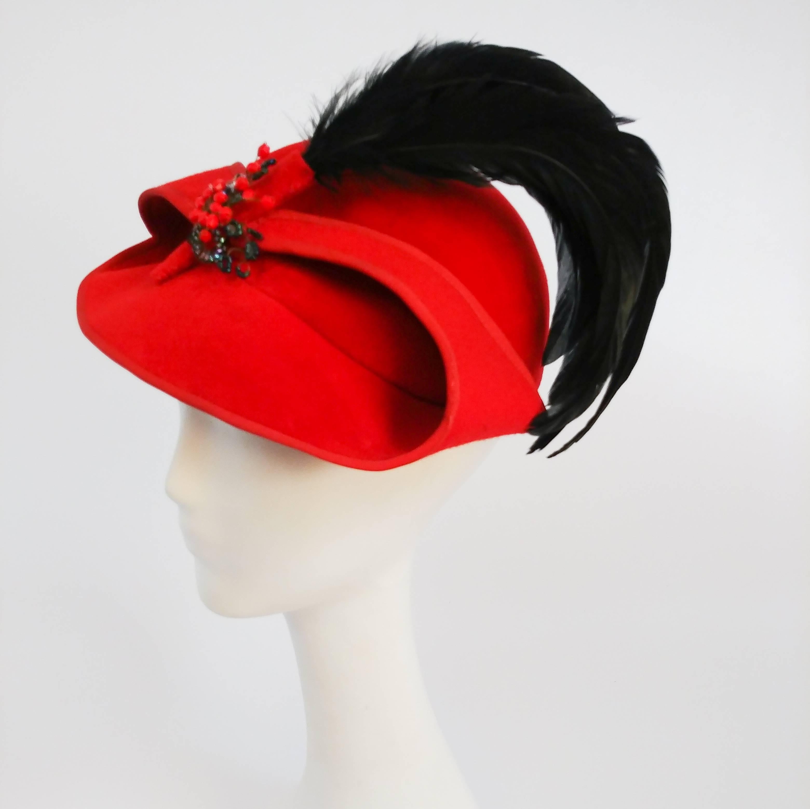 1930s Red Sculptural Velvet Hat w/ Black Feather. Sides of hat flip for visual interest and pinned in place with flower brooch and curled raven feathers. 