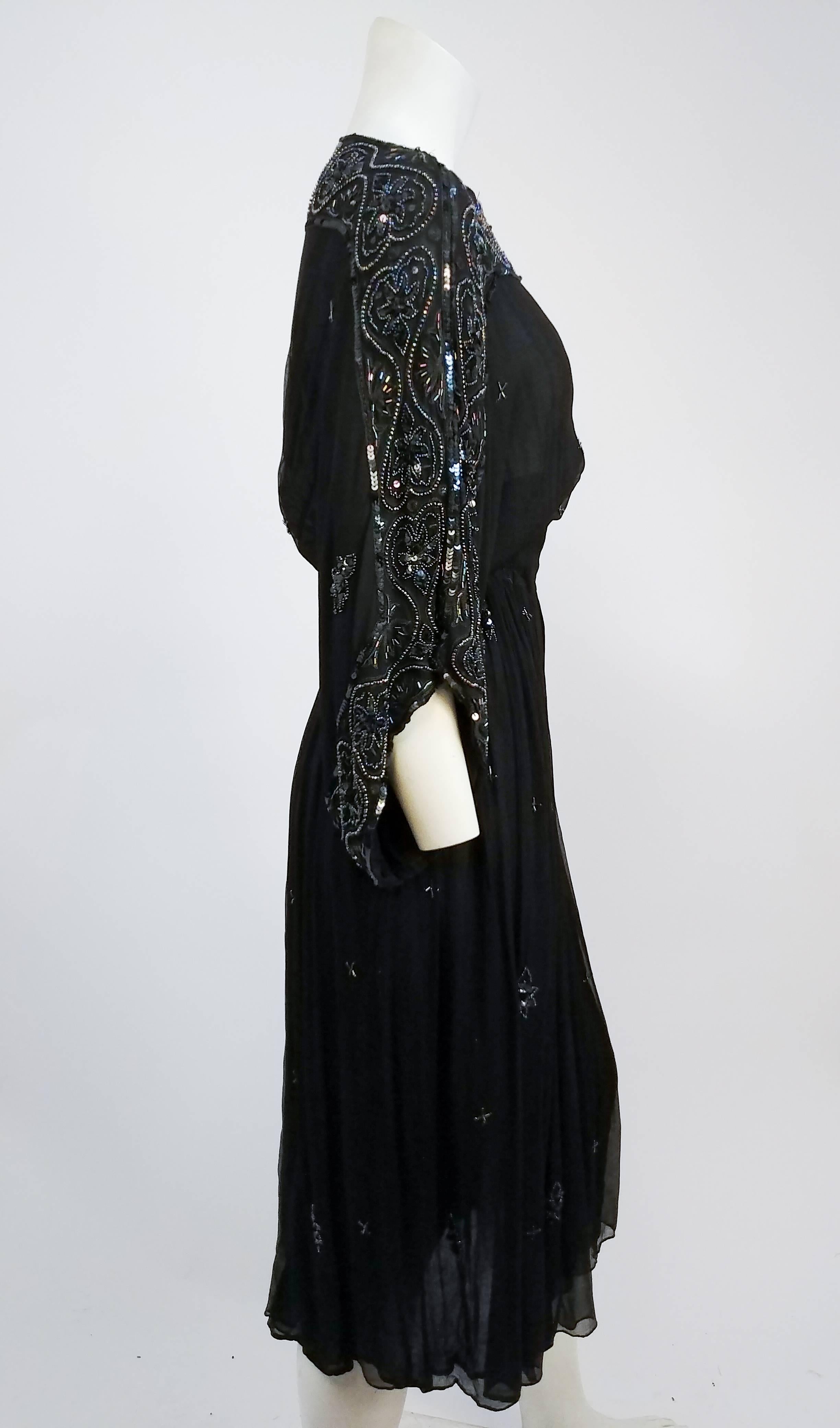 1970s Judith Ann Beaded Silk Chiffon Black Dress. Border beaded onto sleeve and neckline, with sporadic beading throughout bodice and skirt. Elasticated waistband, no closures. Loosely woven black silk chiffon for light, airy feel. 