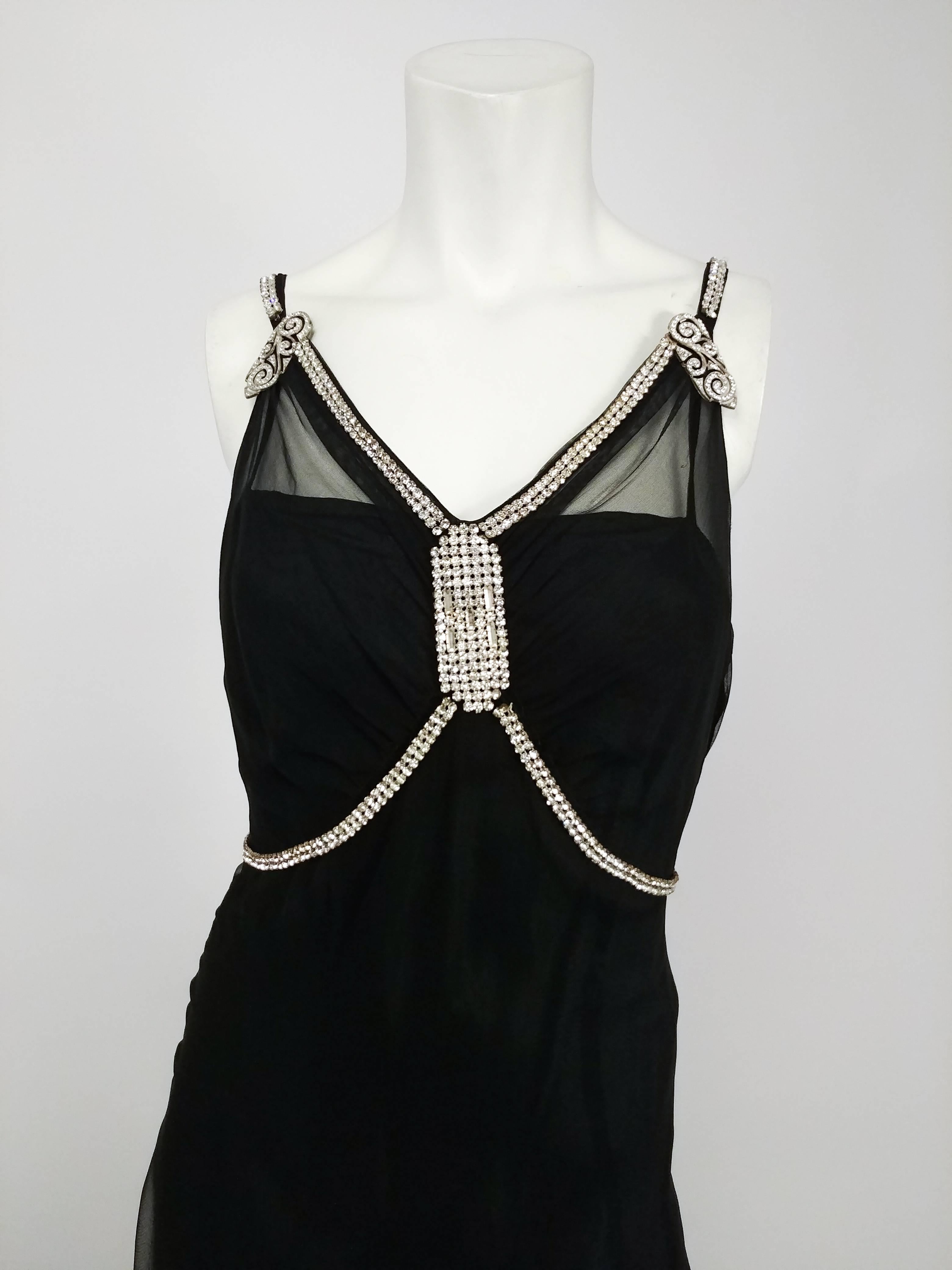 1930s Black Evening Gown w/ Rhinestone Detailing. Mesh overdress with rhinestone halter and art deco style embellishments at bust and straps. Snap closures at side. Comes with 1930s long black slip with low back. 