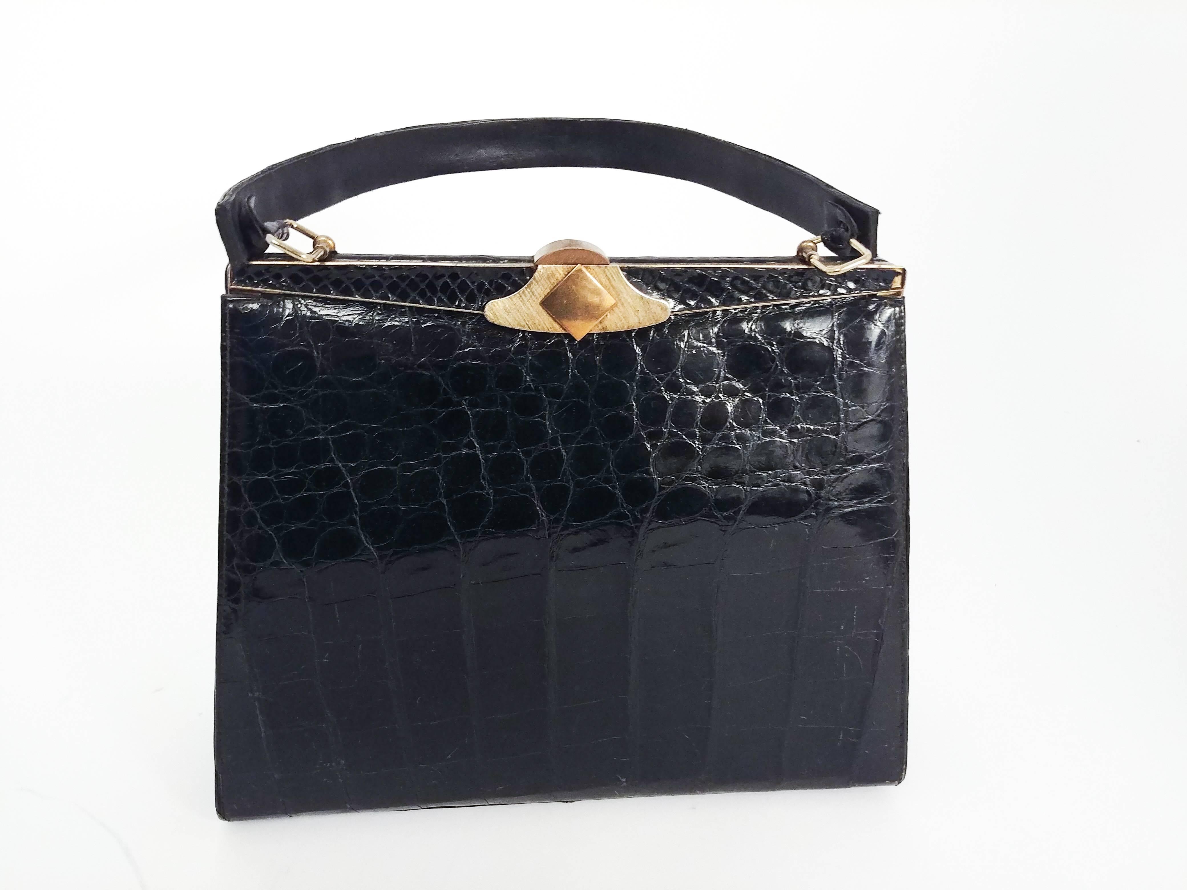 1960s Black Alligator Handbag. Tapered trapezoid shape. Gold tone hardware.