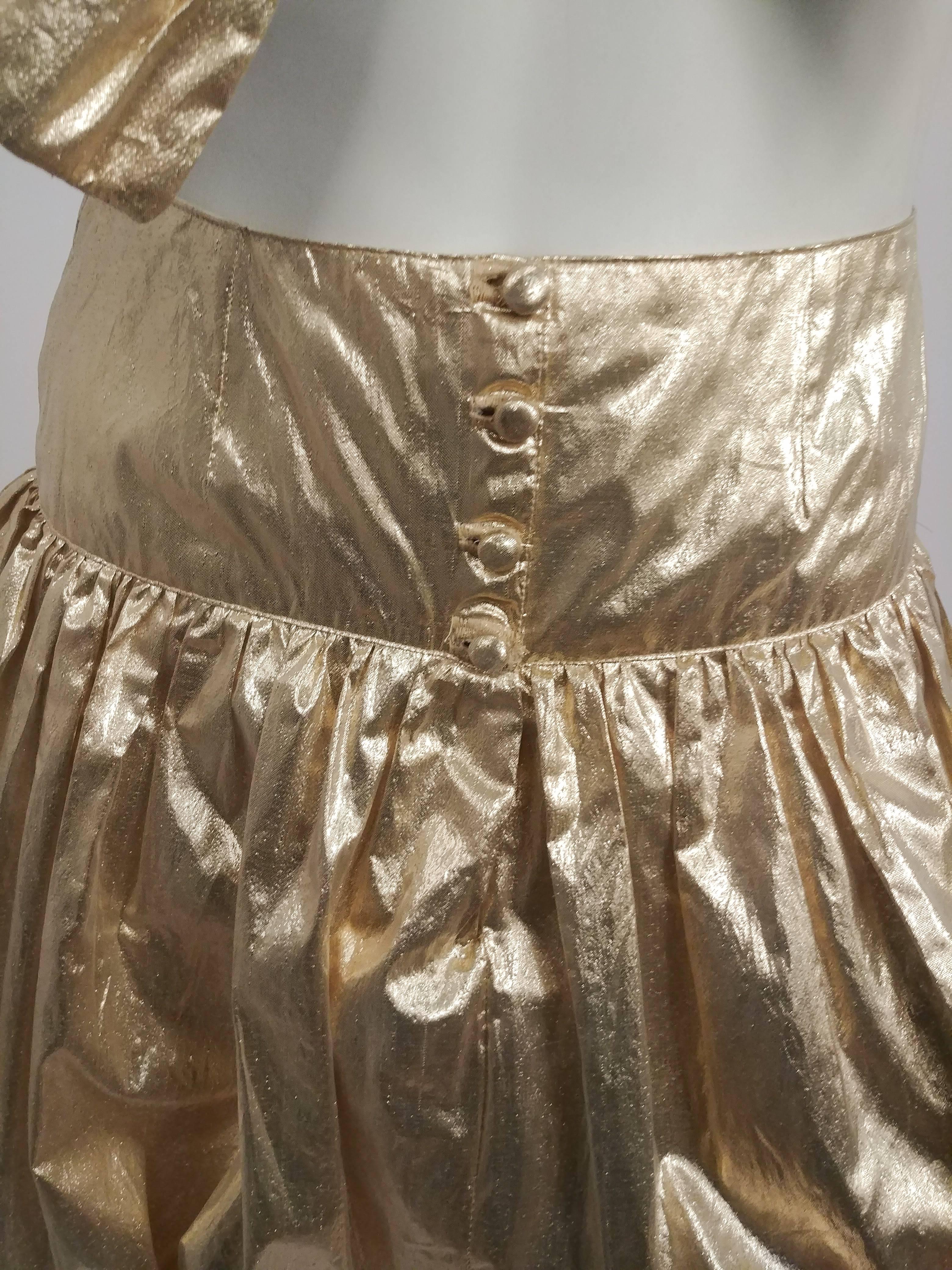 1970s Gold Lamé Bow Top & Bubble Skirt Set. Giant decorative bow covers the front of the bra top, hook & eye claps in back, adjustable. High waisted skirt, buttons up front, extreme bubble effect makes for grate statement piece! 
