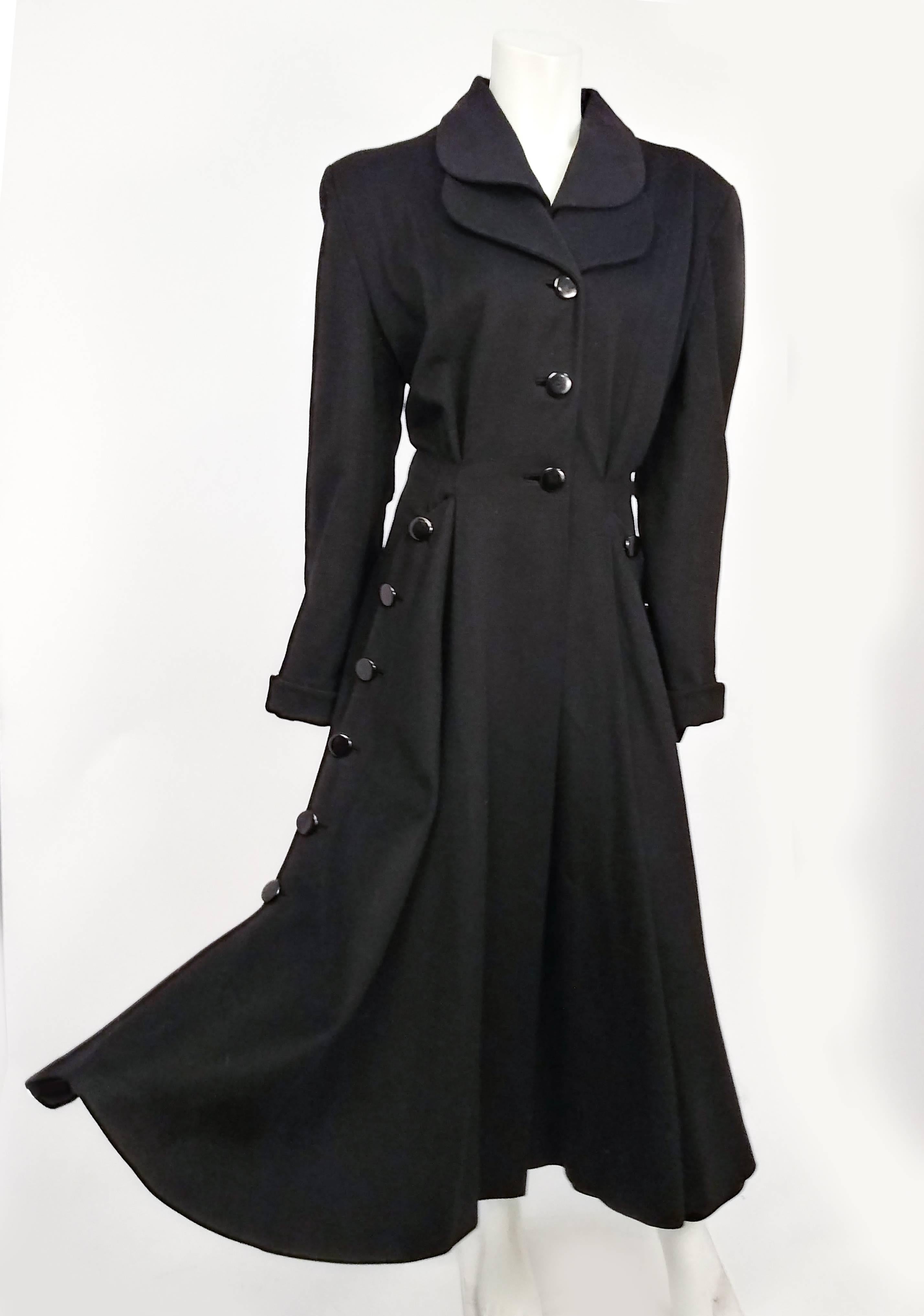 1940s Black Long Wool Noir Coat. Perfect flim noir style coat alludes to a sense of mystery. Interest layered double lapel detail and buttons down the sides, flared skirt perfect for swishing against your stockings as you walk down a dark