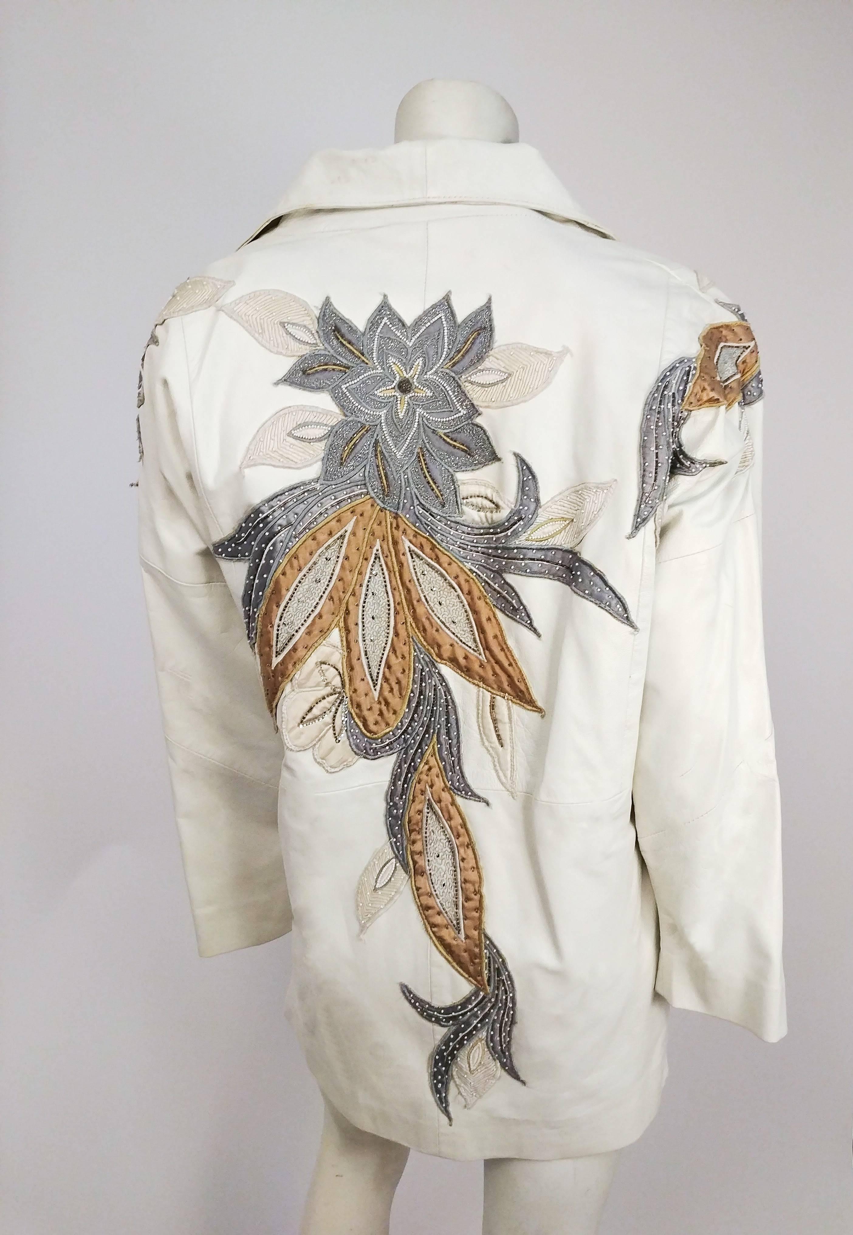 1980s Judith Ann White Leather Jacket. Wide lapels, no closures. Asymmetrical flower applique design on shoulders and back. Cocoon coat shape with slouchy shoulders. 