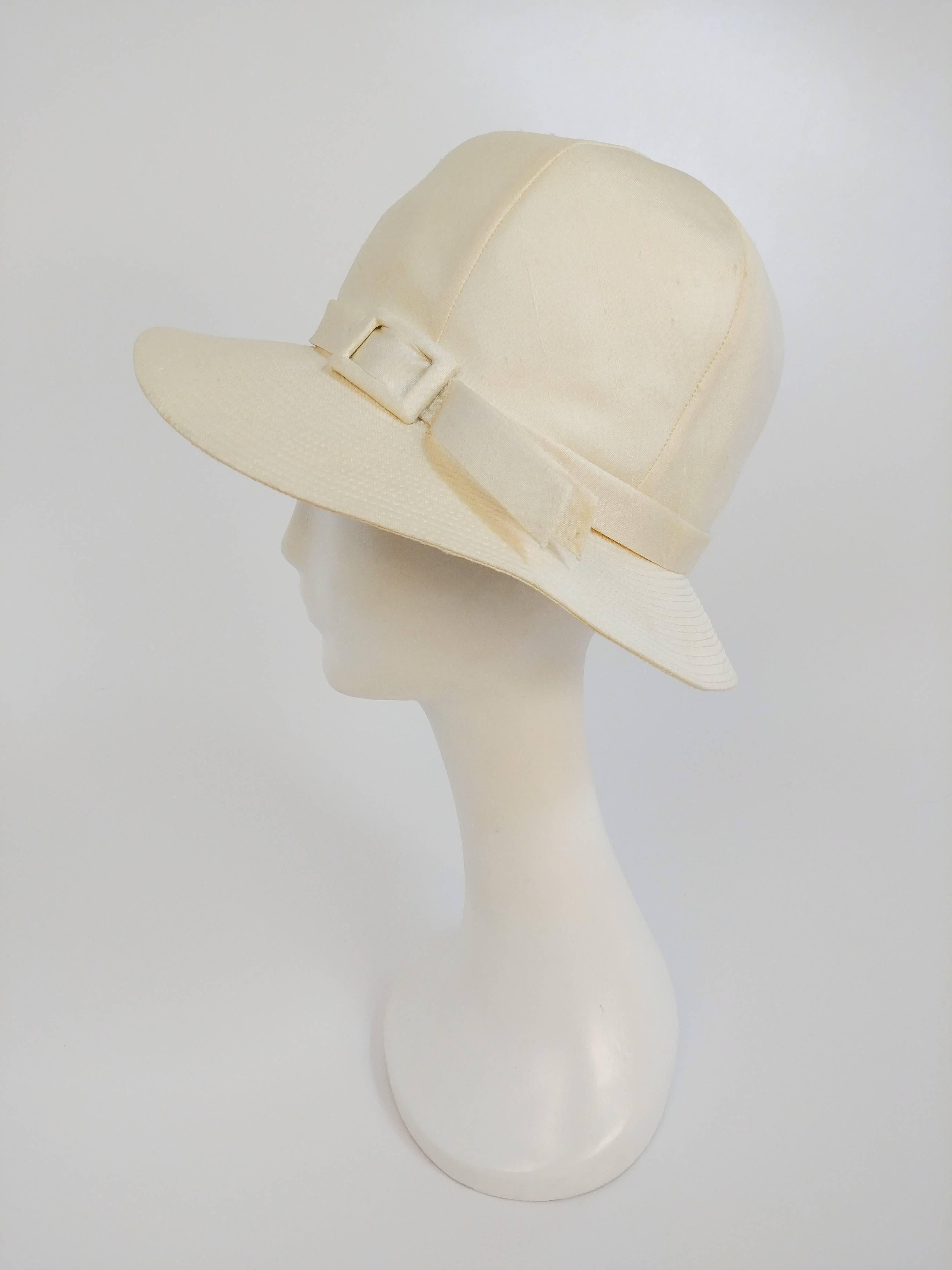 1960s White Mod Linen Cloche Hat. Two buckles decorate front. 