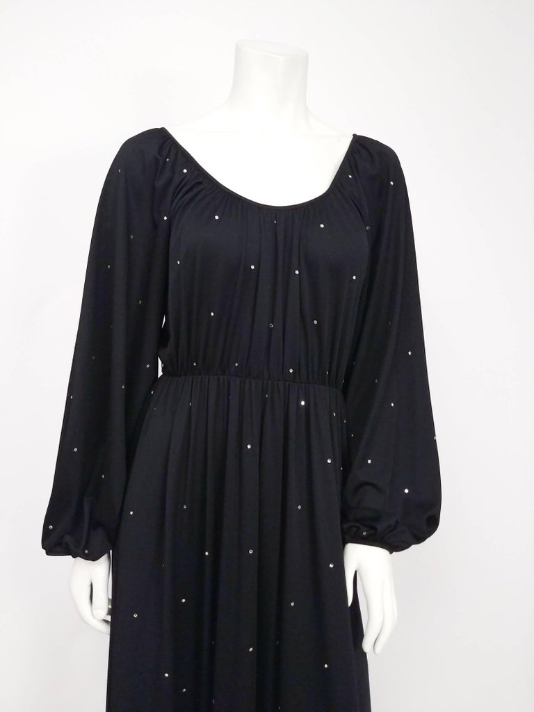 1970s Black Rhinestone Dress. Draped rayon knit dress embellished with all-over rhinestones. Scoop neck and billowing sleeves zips up back. 