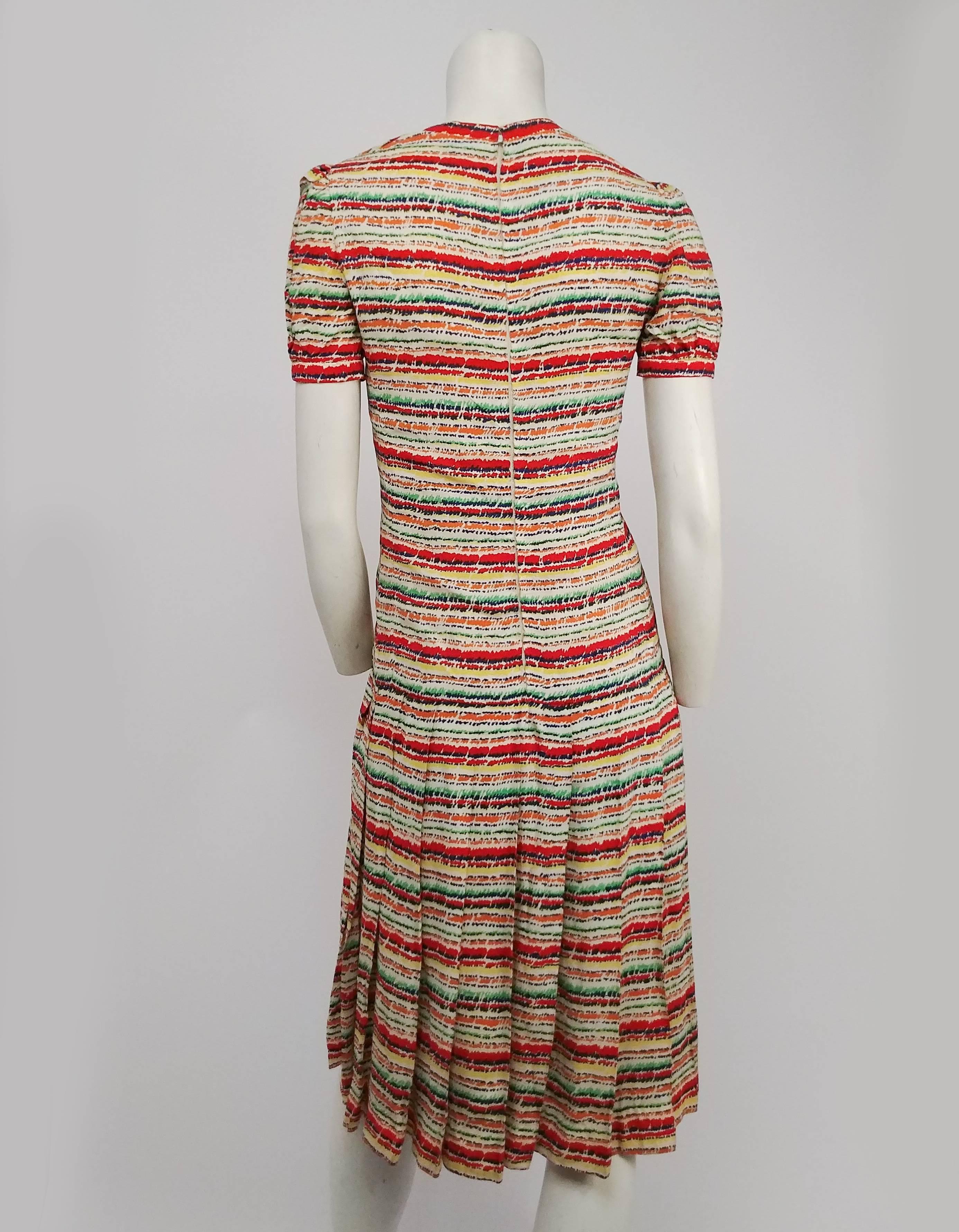 1970s Scherrer Boutique Striped Pleated Day Dress.  Schemer Boutique sold at Bergdorf Goodman. Colorful striped day dress, V neck, short puff sleeves, low waisted pleated skirt, zips up back, hand set lining. 
