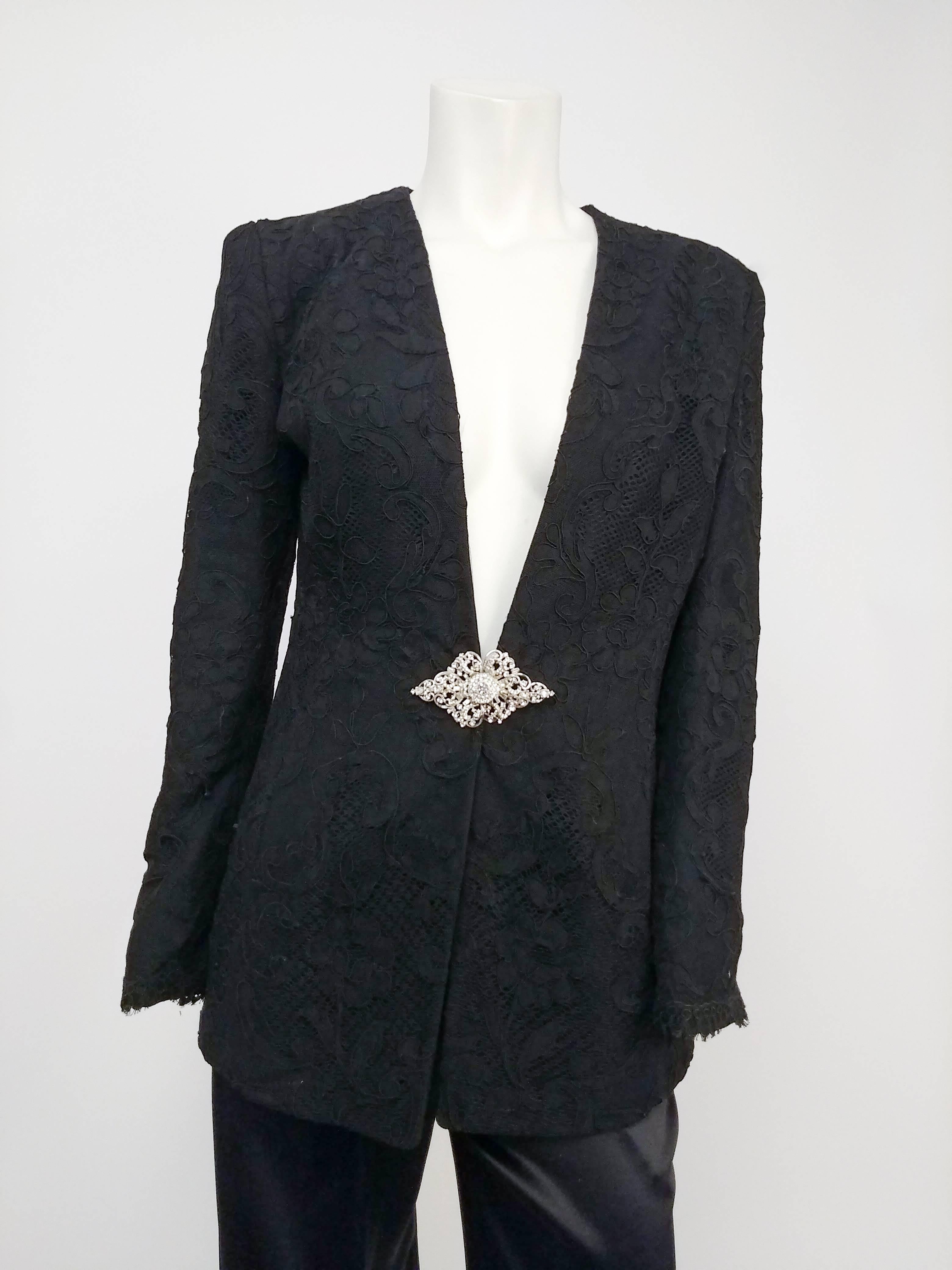 1980s Badgley Mischka Lace Blazer & Satin Trouser Pantsuit. Low cut collarless lace blazer fastens with rhinestone clasp at front. Padded shoulders. High waisted pleat front satin trousers. 
