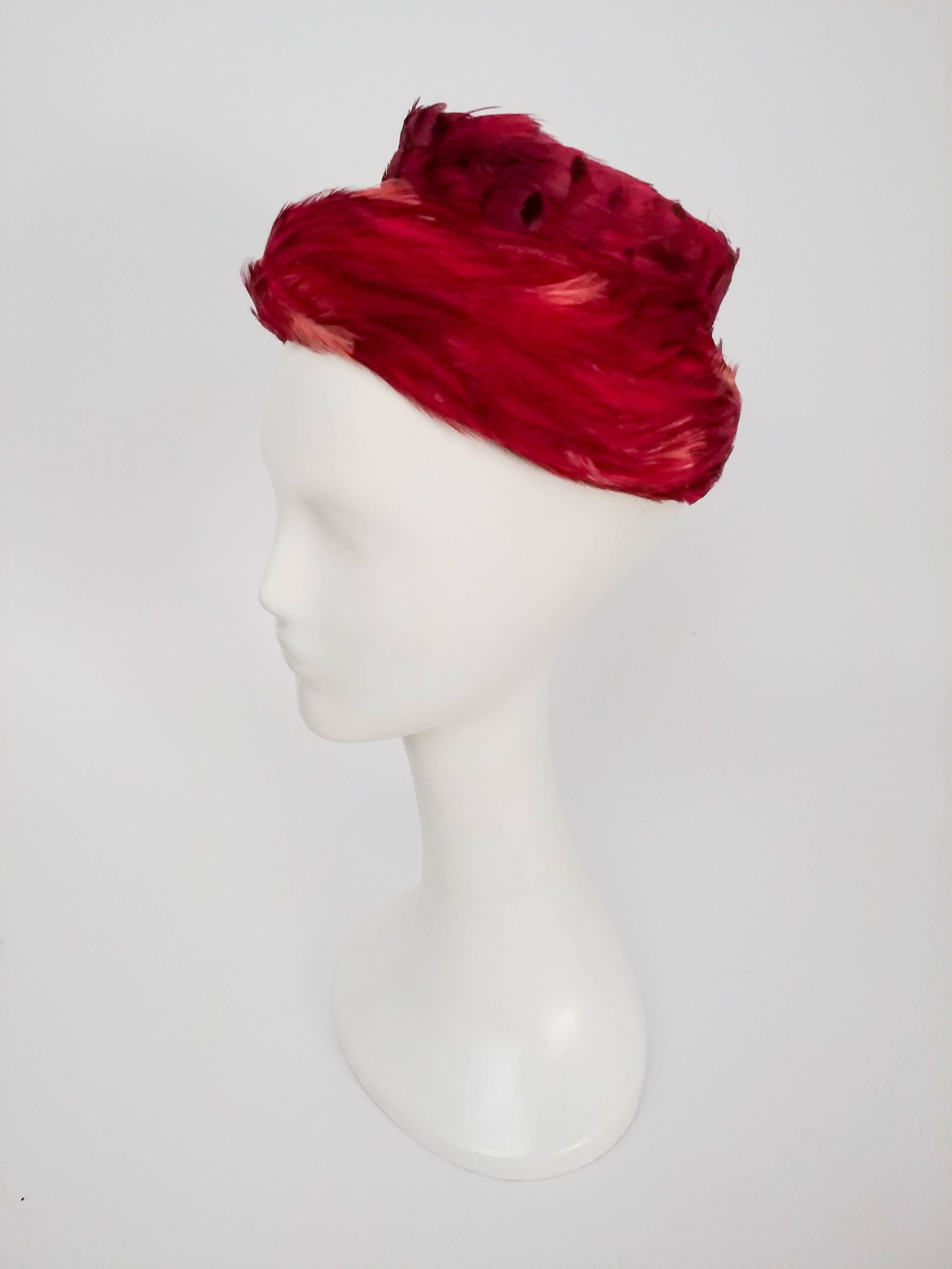 1960s Rose Pink Structured Feather Hat. Dyed feathers cover the entirety of this hat, which features a structured crown covered with spelled feathers and a wispy brim. 