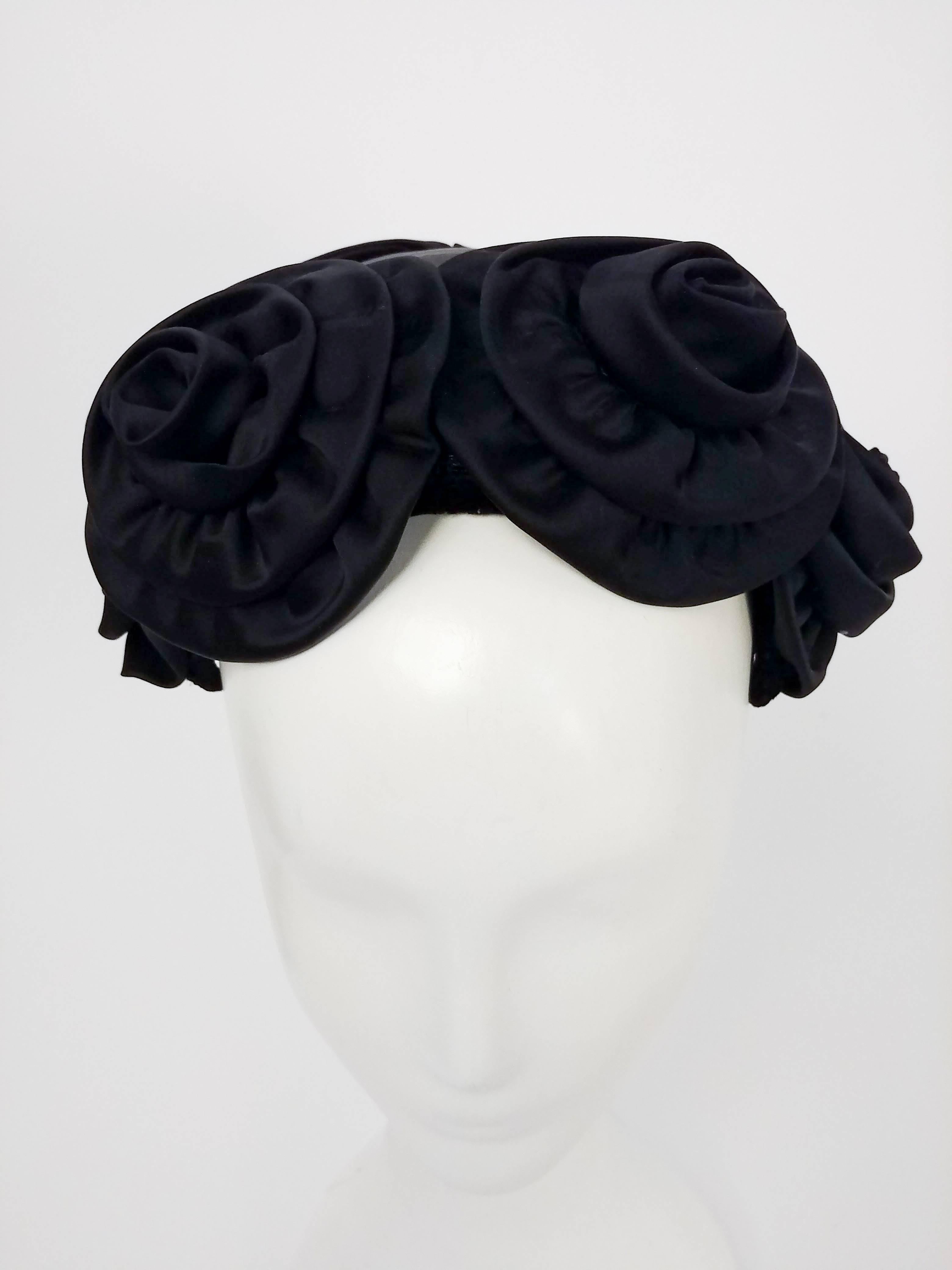 1950s Black Rosette Cocktail Hat. Four large rosettes adorn the top of this fabulous 1950s cocktail hat, finished in the back with a large bow. Lined in lace, velvet trim.