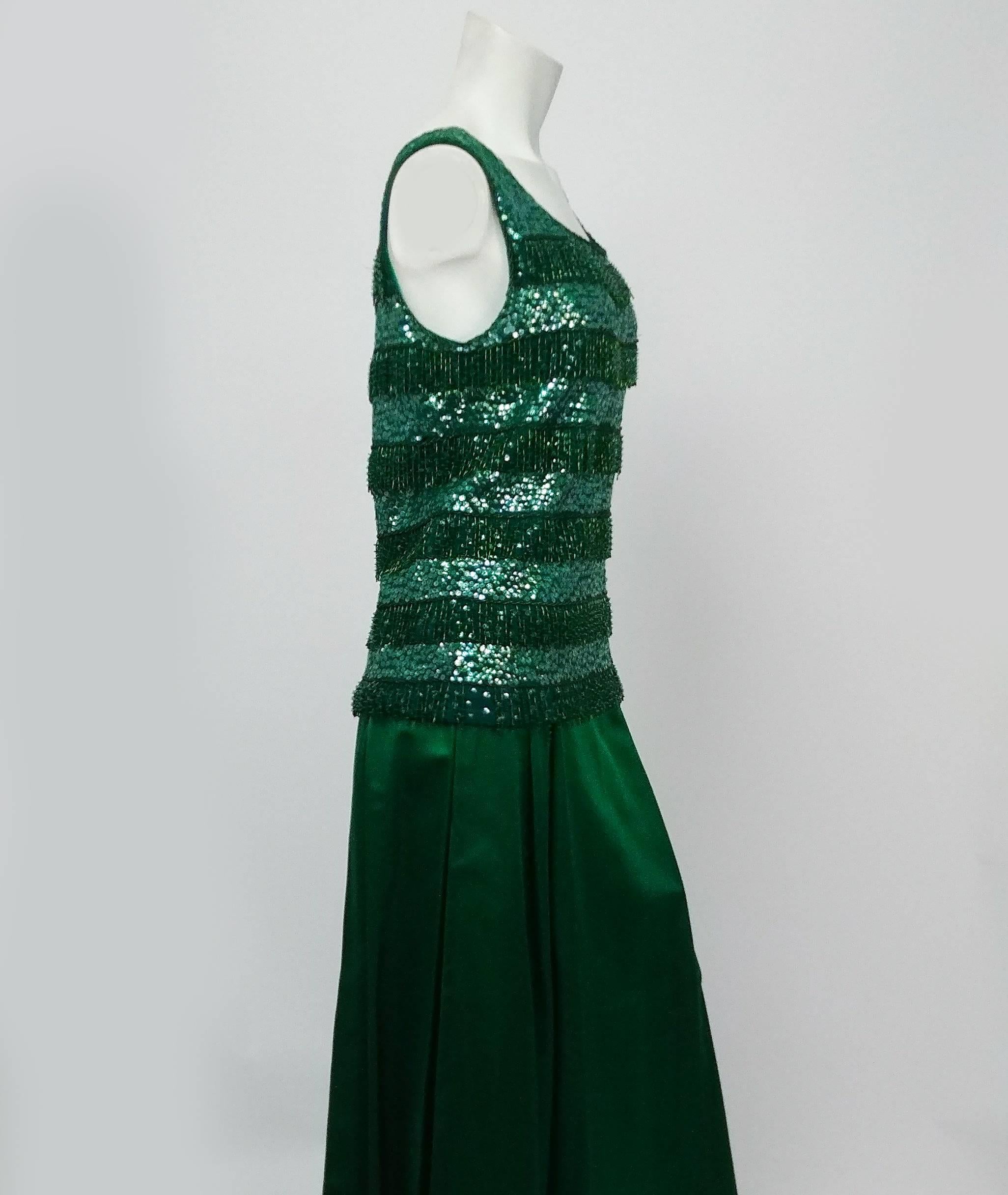 1960s Emerald Green Sequin Top & Satin Evening Skirt. Knit top fully beaded and sequined, zips up back and lined with silk. Long evening skirt is a heavy, luscious satin, pleated at waist and zips up side.  