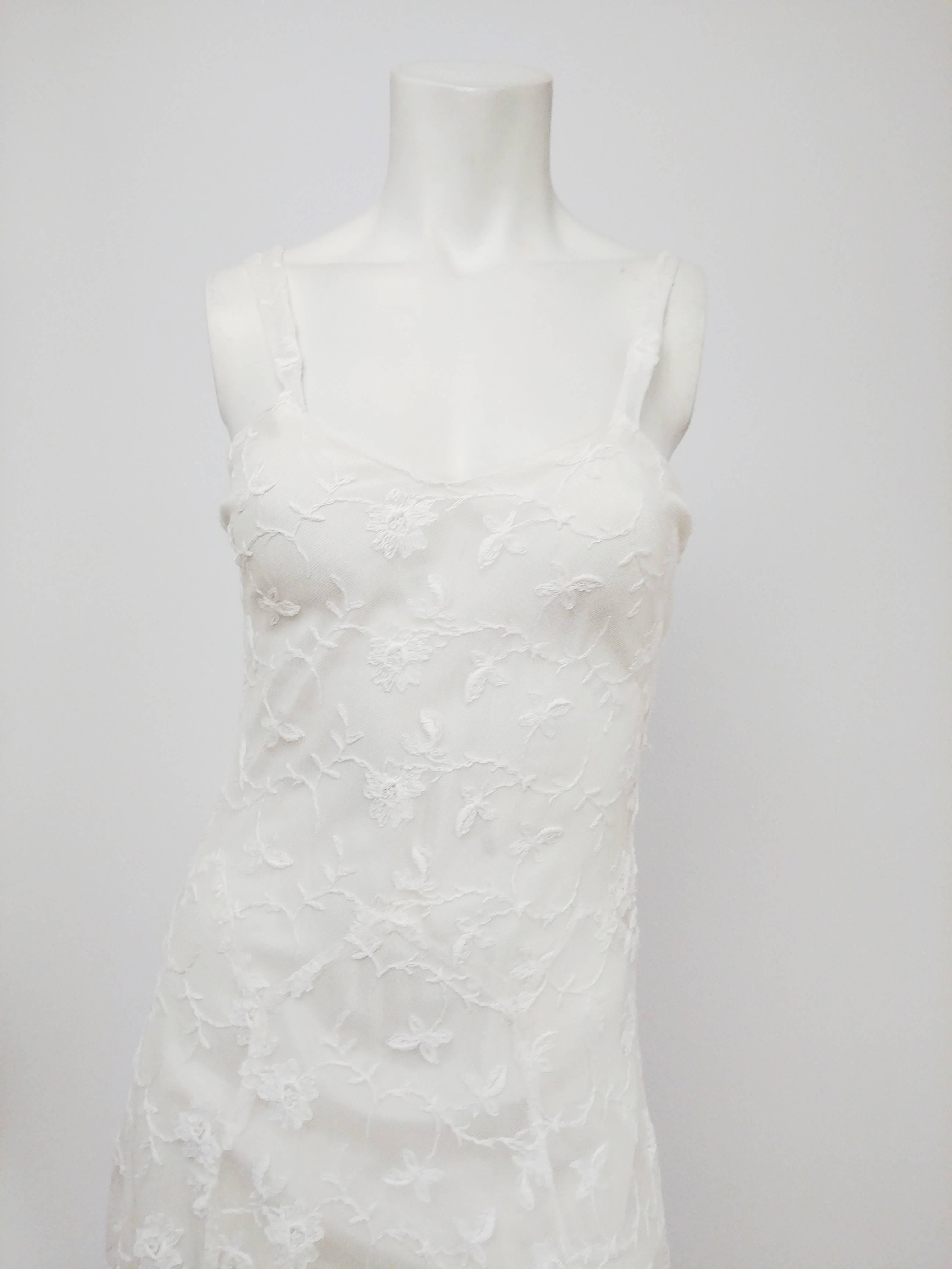 1930s White Lace Wedding Dress. White all-over lace dress over built-in slip. Side snap closures. Zigzag waist seam adds subtle detail and lines to this elegant, simple dress.