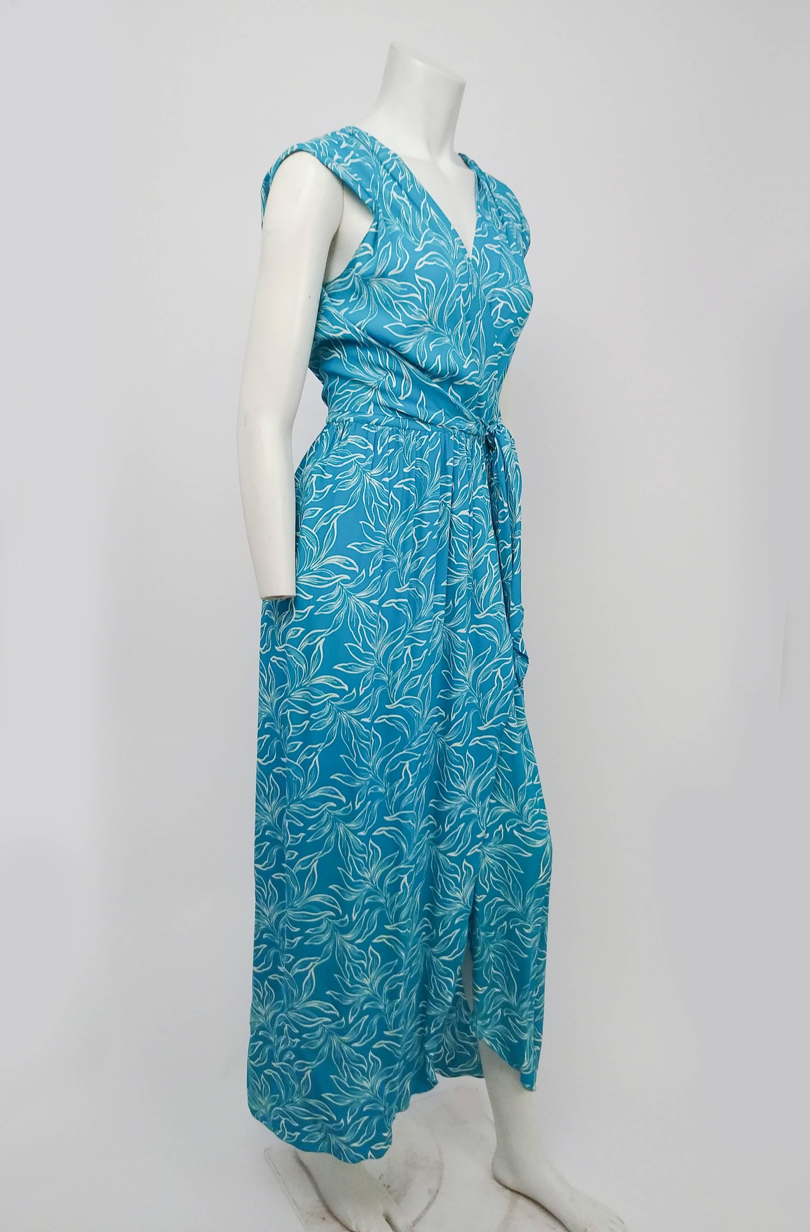 1970s Adele Simpson Summer Wrap Dress w/ Cowl Back. Cerulean blue printed crepe fabric snaps closed at waist. Cowl neck back is weighed down for perfect drape, and extends around to front to tie around waist. 