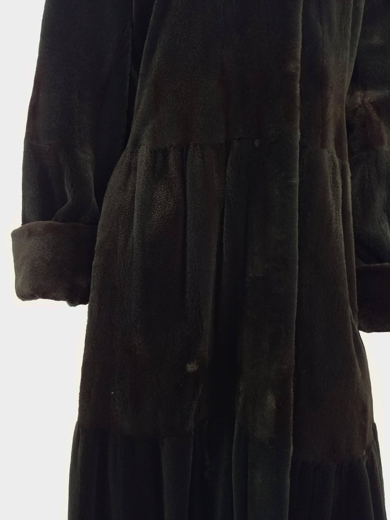 1980s Green Shorn Mink Long Coat. Dyed dark aqua green, visible striping of mink's natural patterns still visible in light. Gathered at back yoke for fullness. Toggle closure at neck, and snaps closed with fur clasps down front. Beautiful tiered