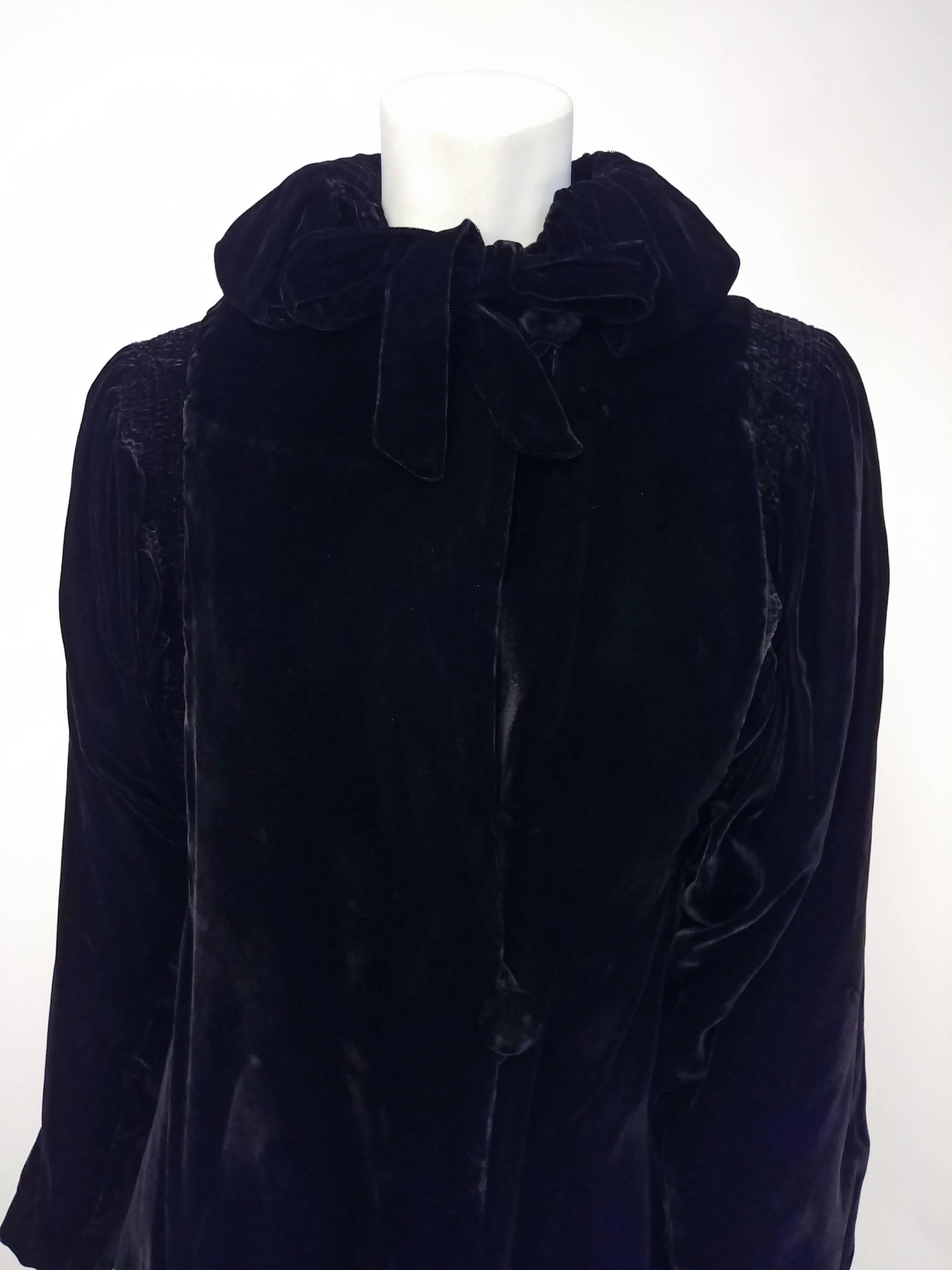 1940s Black Silk Velvet Opera Coat. Full length velvet coat with smocking detail at shoulders and back neck, ties at front neck and buttons down front. 

Shoulder to shoulder: 16