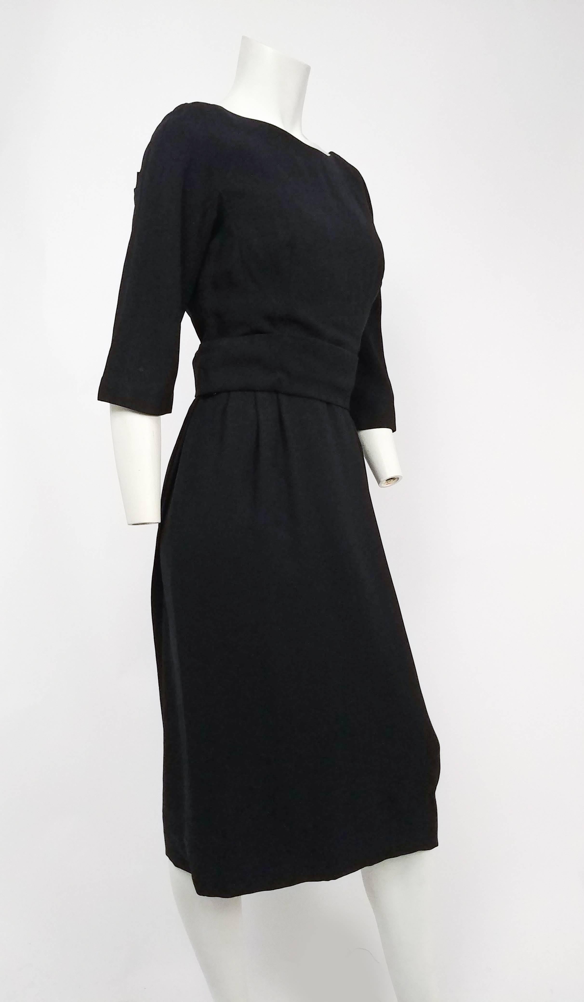1950s Adele Simpson Black Draped Back Cocktail Dress. Amazingly constructed cocktail dress with demure front and low-back draped back. Glove-length sleeves, lined in organza. 