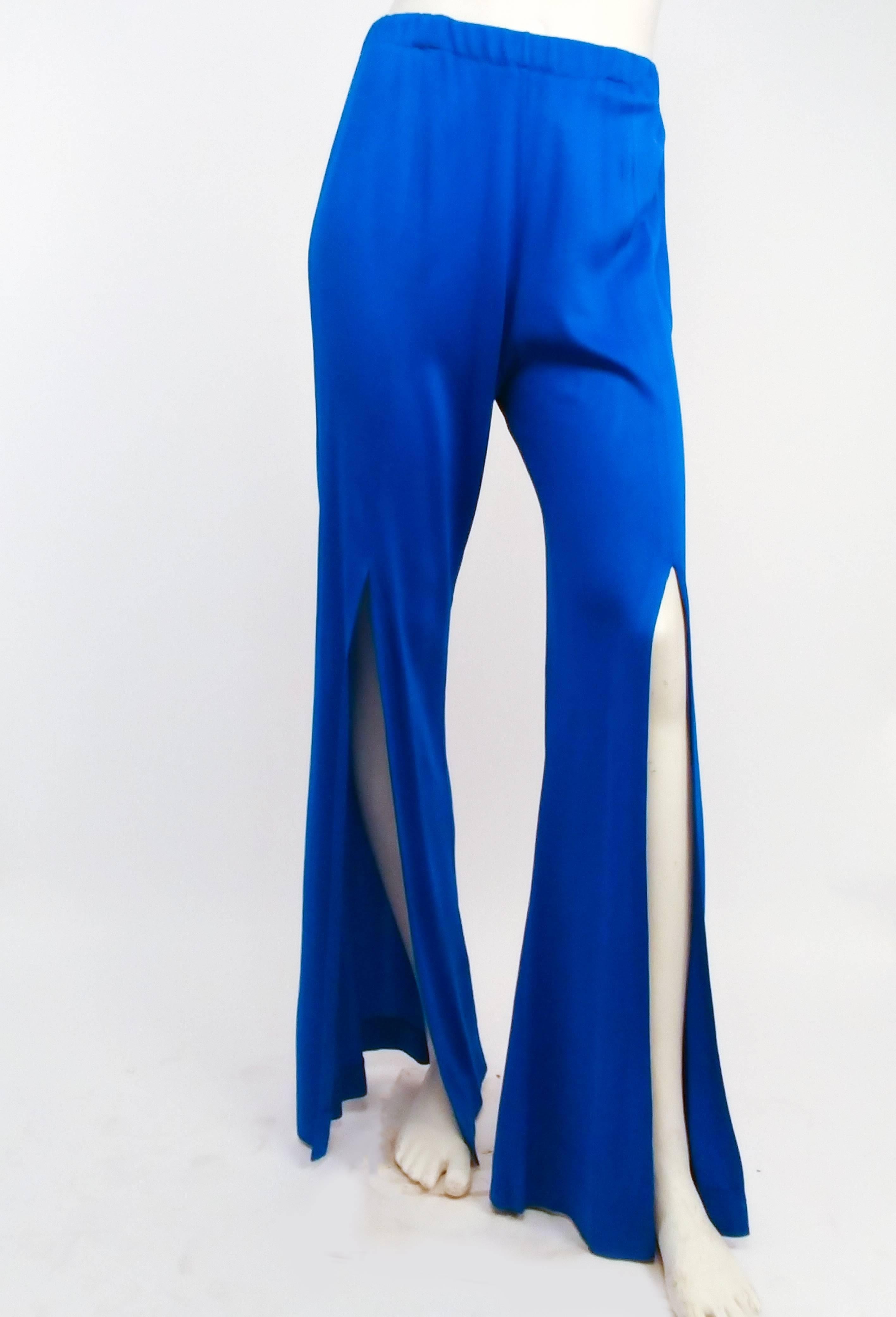 1970s Electric Blue Tunic Top & Flare Pants Disco Set. Wide scoop neck collar, zips up back. Decorative button placket on one side at hem. Pants have elasticized waist and slits up to the upper knees. 