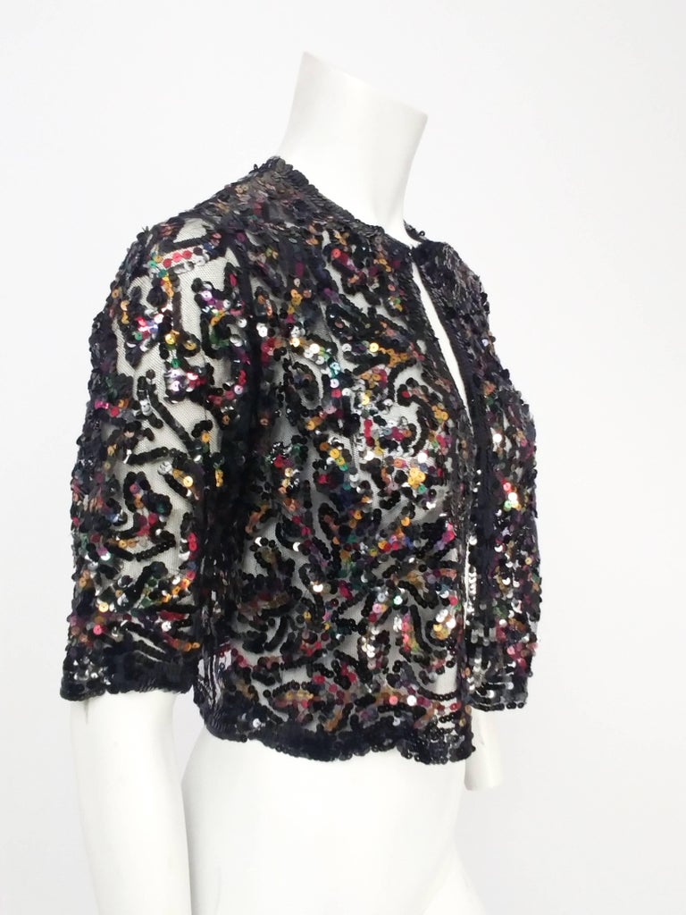 1930s Rainbow Sequin Black Mesh Cropped Bolero Jacket. Adorable cropped mesh jacket to cover up during an evening out. Closes at throat with hook & eye. Unlined. 