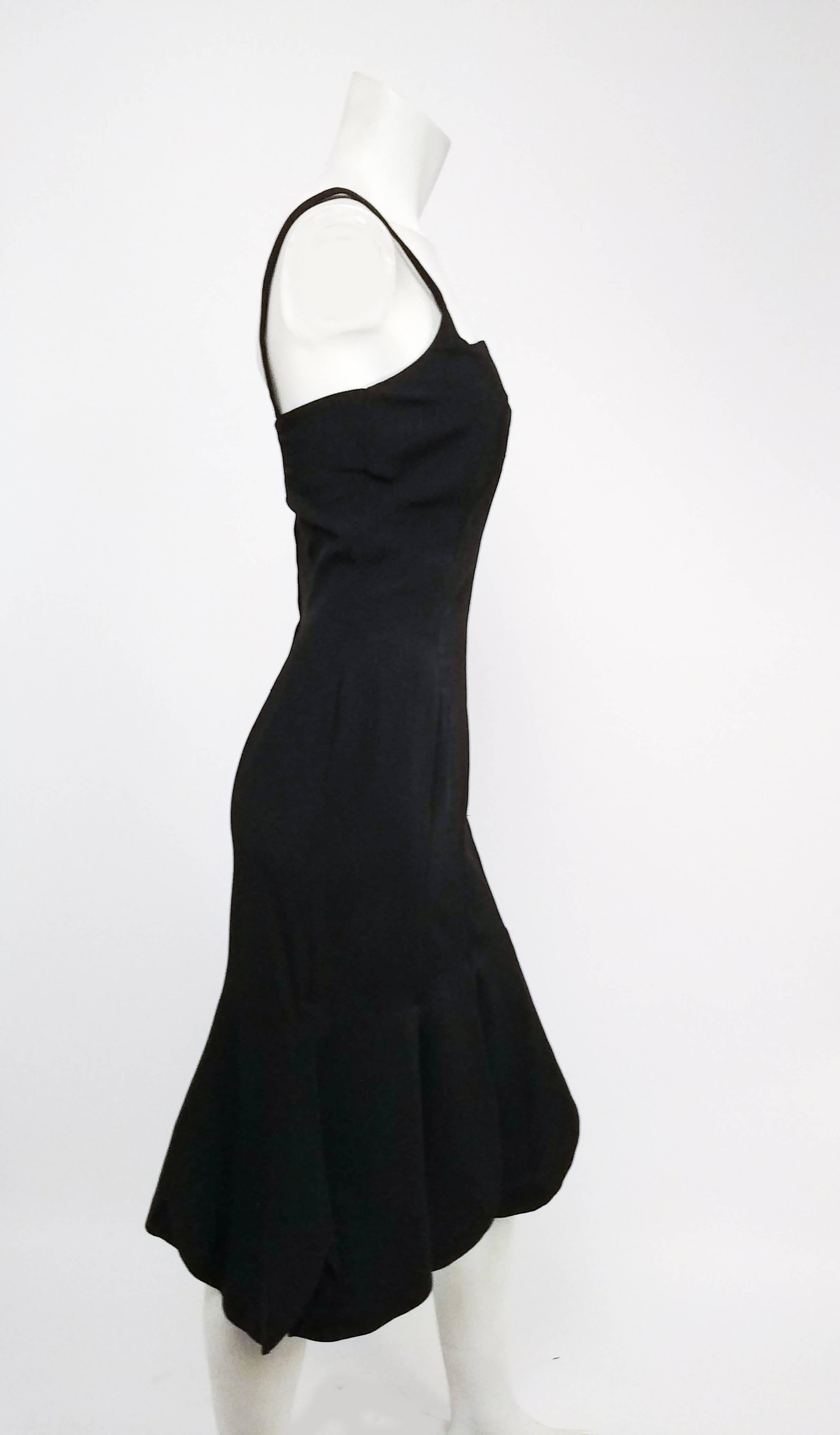 1960s Black Petal Hem Cocktail Dress. Black crepe fabric. Sweetheart neckline. Flares out at the knee with some extreme scallops which look like flower petals! Zips up back. 