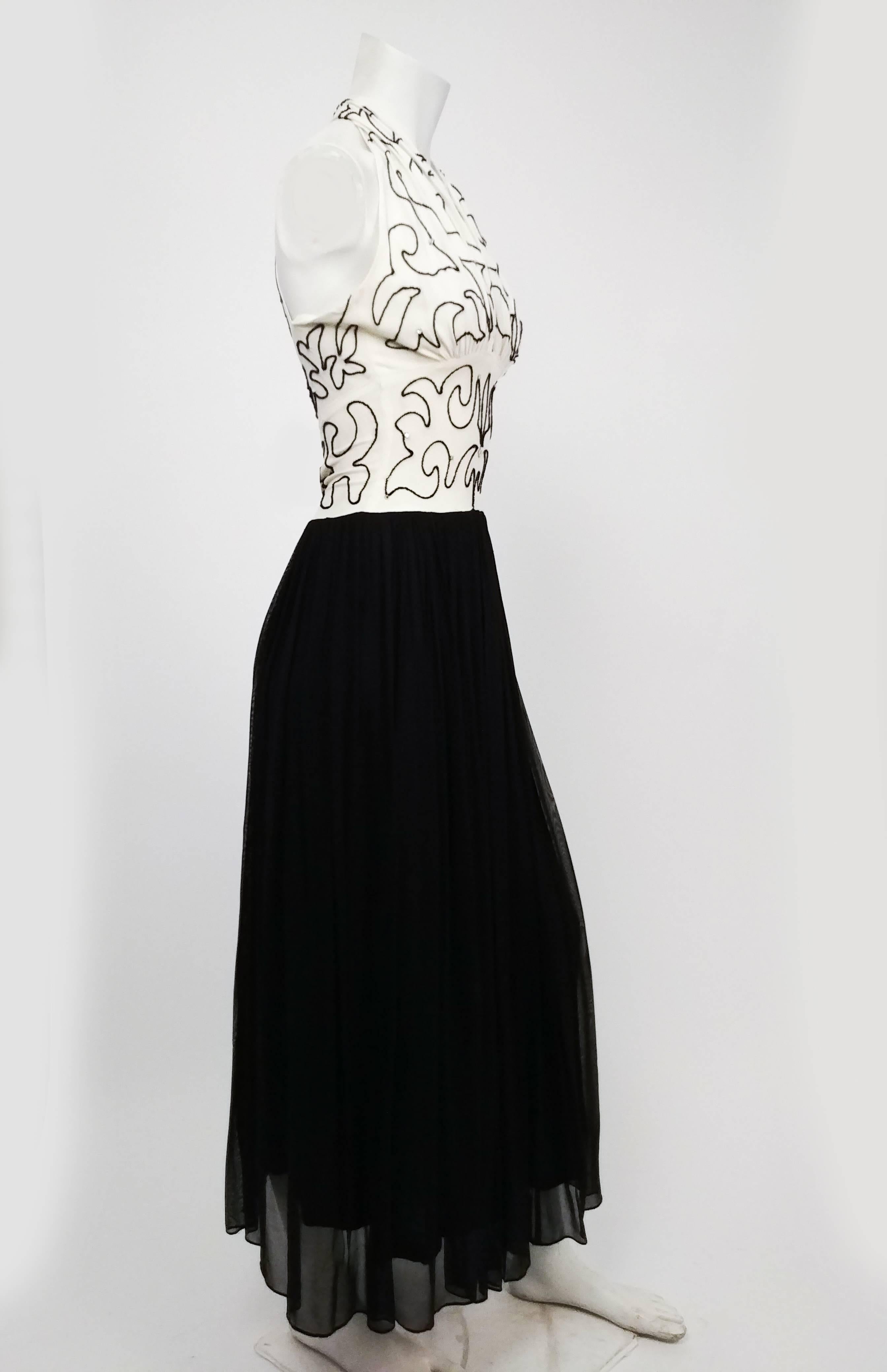 1930s Black & White Beaded Halter Evening Dress. Exquisite white bodice beaded with black beads and rhinestones, deep V neckline with halter straps. Flowing black mesh skirt with plenty of movement. Back closes with hook and eyes, with sexy keyhole