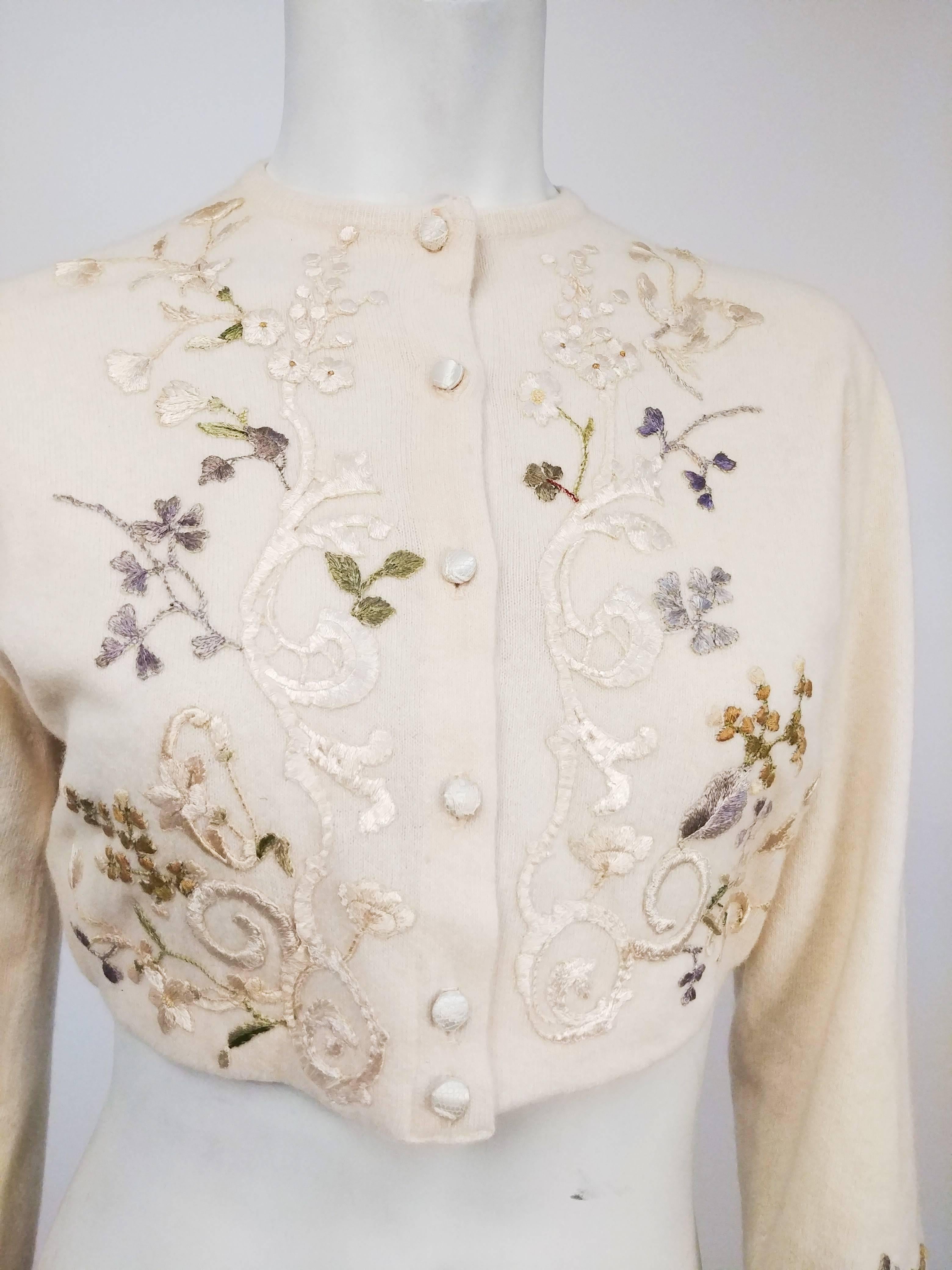 1950s Helen Bond Carruthers Embroidered Applique Cardigan Sweater. Cropped cashmere ivory sweater by Dalton customized by designer Helen Bond Carruthers, known for one-of-a-kind artistic embellished high-end sweaters using vintage trims and