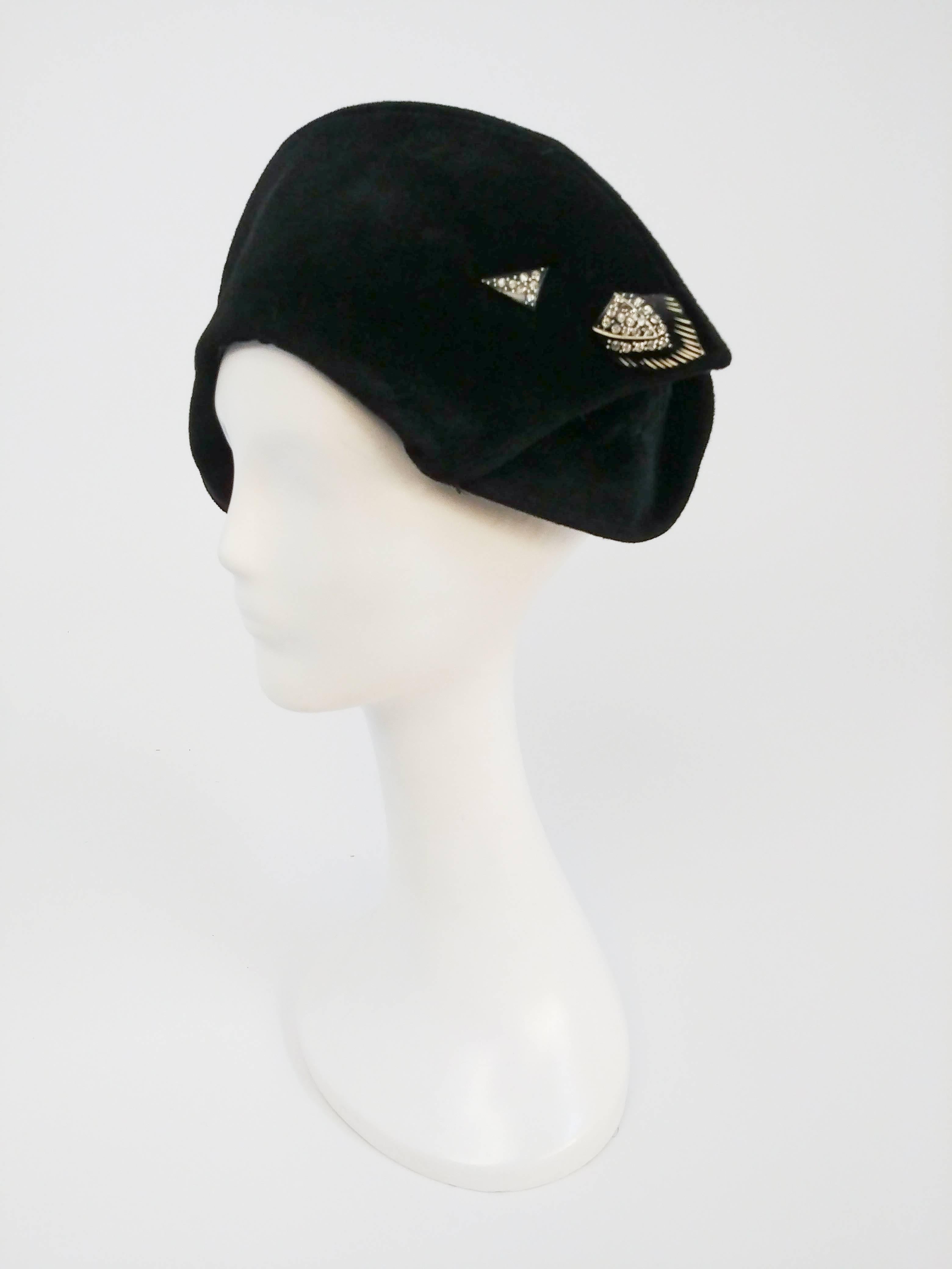 1930s Black Art Deco Asymmetrical Hat. Sculptural 1930s felt hat covers one ear, embellished with an Art Deco rhinestone pin at other side. 